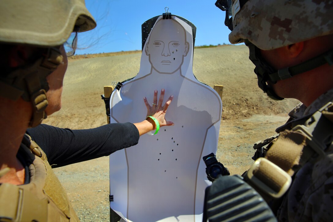 Andrea Lillywhite observes her shot group after firing the M27 Infantry Automatic Rifle during the Jane Wayne Day event at the School of Infantry here, Aug. 9.

The day started off with one group breaking off to learn how to operate different weapons systems such as the M16 service rifle and the M9 service pistols using the Indoor Simulated Marksmanship Trainer. They travelled to Range 210C to conduct a live-fire shoot with the M27 Infantry Automatic Rifle.

"It was a fun experience," said Kaylee Walter, whose husband serves as the executive officer for India Company, Marine Combat Training Battalion, SOI-W. "It was surprising how heavy the weapon was and how hard it was to hit the target. It really gave me a whole new understanding and appreciation as to what my husband does."

