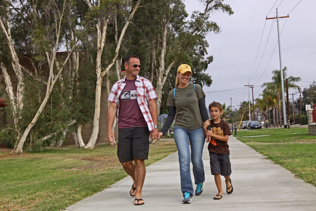 Capt. David Rooks, company commander, India Company, Marine Combat Training Battalion, School of Infantry-West, strolls with his wife Melissa and his son Zachary, six, before participating in a Jane Wayne Day event at the School of Infantry here, Aug. 9.

The day started off with one group breaking off to learn how to operate different weapons systems such as the M16 service rifle and the M9 service pistols using the Indoor Simulated Marksmanship Trainer. They travelled to Range 210C to conduct a live-fire shoot with the M27 Infantry Automatic Rifle.

"It was a fun experience," said Kaylee Walter, whose husband serves as the executive officer for India Company, Marine Combat Training Battalion, SOI-W. "It was surprising how heavy the weapon was and how hard it was to hit the target. It really gave me a whole new understanding and appreciation as to what my husband does."