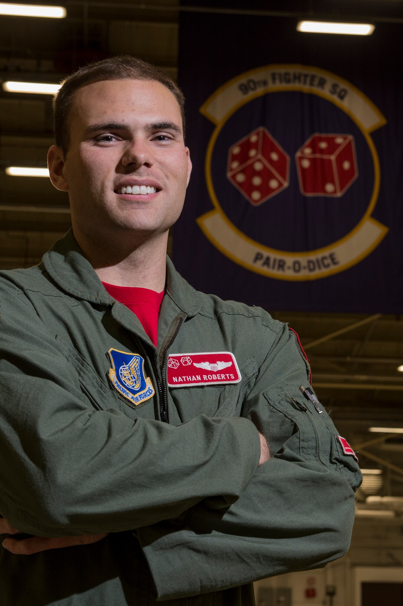 U.S. Air Force Capt. Nathan Roberts, 90th Fighter Squadron F-22 Raptor pilot, poses for a portrait at Joint Base Elmendorf-Richardson, Alaska, during a training mission, Aug. 8, 2014.  The F-22 is designed to project air dominance rapidly and at great distances. (U.S. Air Force photo by Staff Sgt. Stephany Richards/ Released)