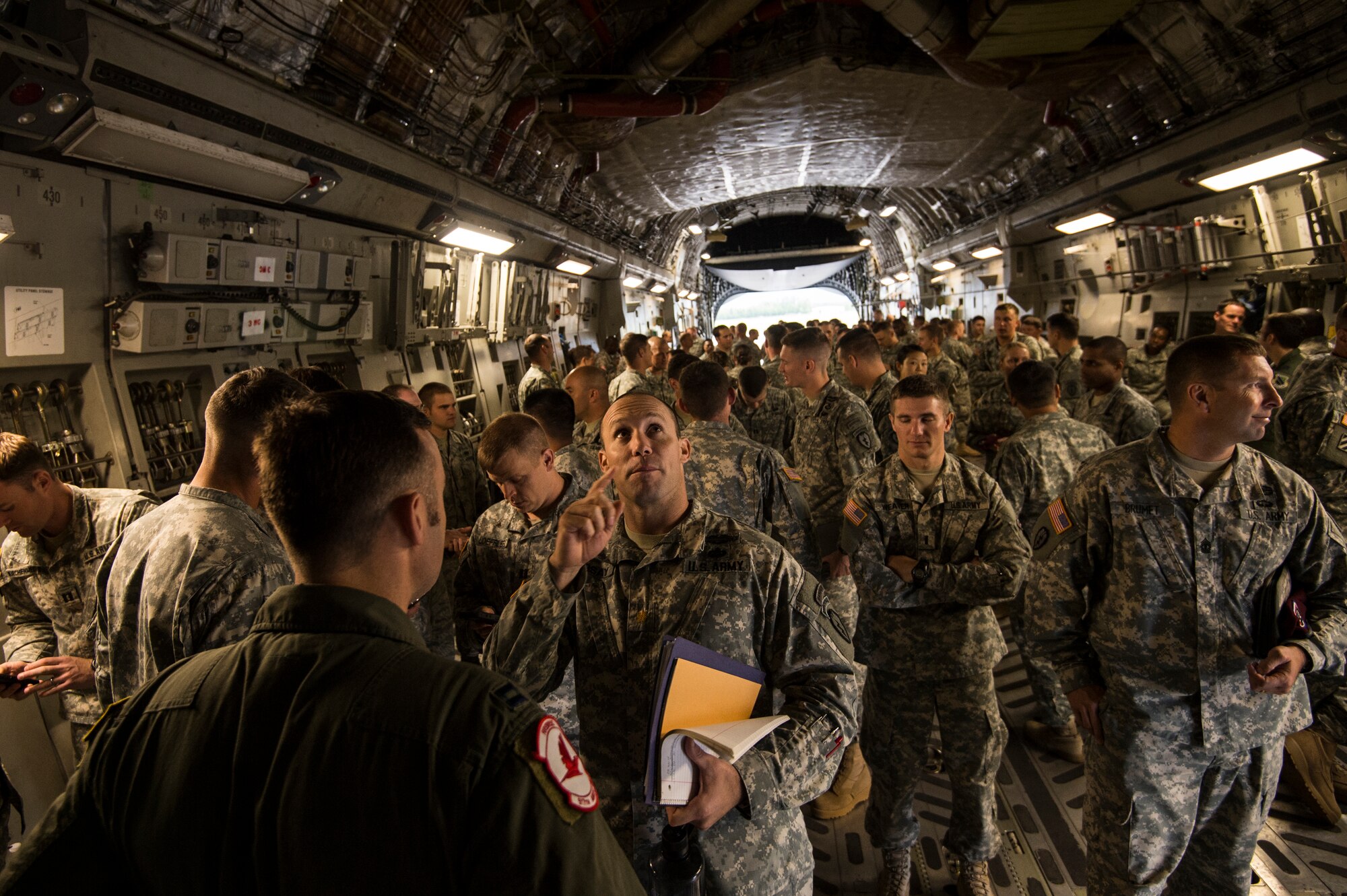 U.S. Air Force Capt. Bill Walker, 517th Airlift Squadron pilot, answers questions from the U.S. Army 4-25 Airborne Brigade Combat Team member inside a C-17 Globemaster III at Joint Base Elmendorf- Richardson, Alaska, Aug. 8, 2014. The 517th AS was showing support for local Army jumpers by giving them a tour of the aircraft and answering questions. (U.S. Air Force photo by Staff Sgt. Stephany Richards/ Released)