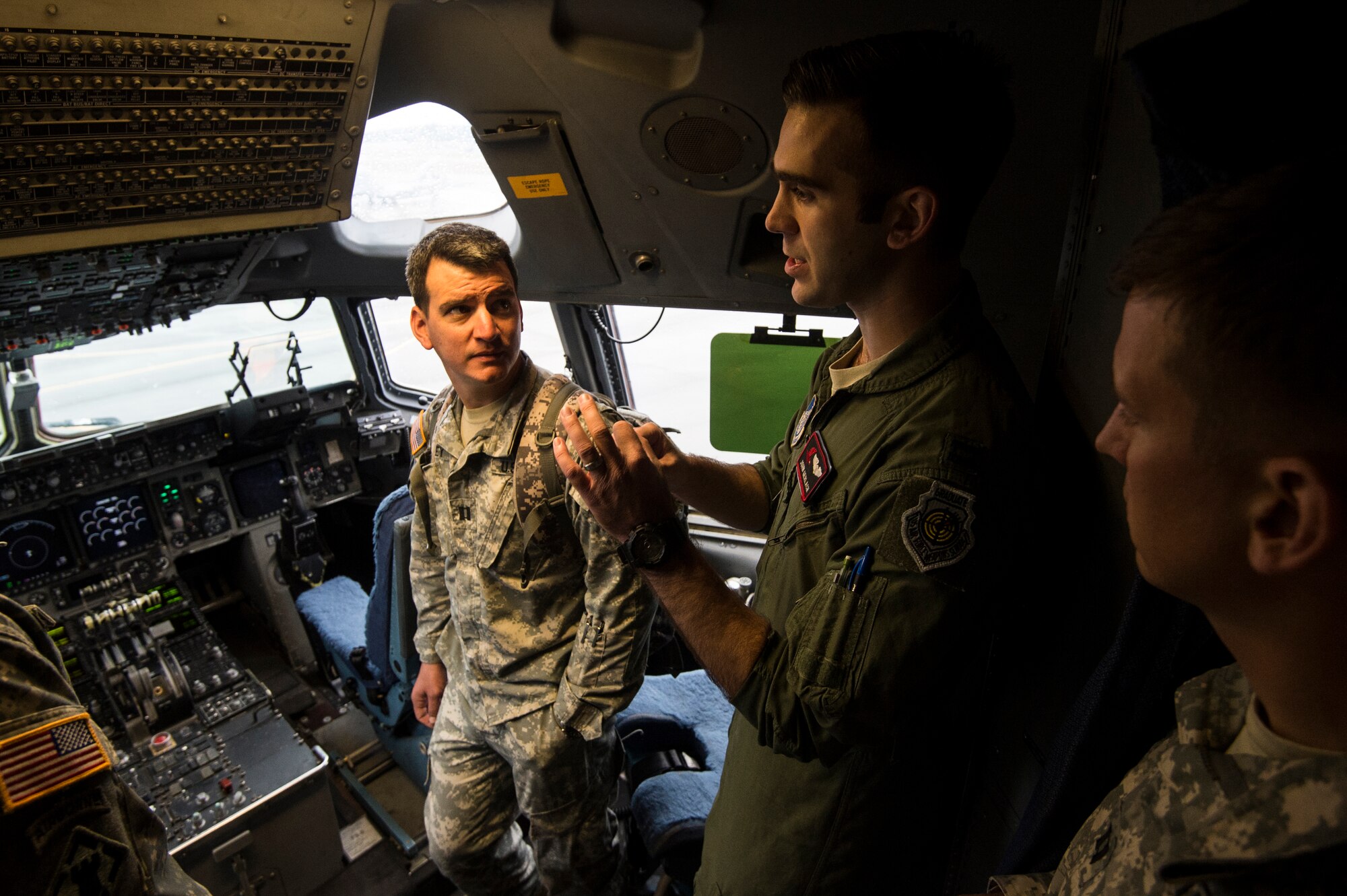 U.S. Air Force 1st Lt. Ryan Vesen, 517th Airlift Squadron pilot, answers questions from U.S. Army 4-25 Airborne Brigade Combat Team member inside a C-17 Globemaster III at Joint Base Elmendorf- Richardson, Alaska, Aug. 8, 2014. The 517th AS was showing support for local Army jumpers by giving them a tour of the aircraft and answering questions. (U.S. Air Force photo by Staff Sgt. Stephany Richards/ Released)
