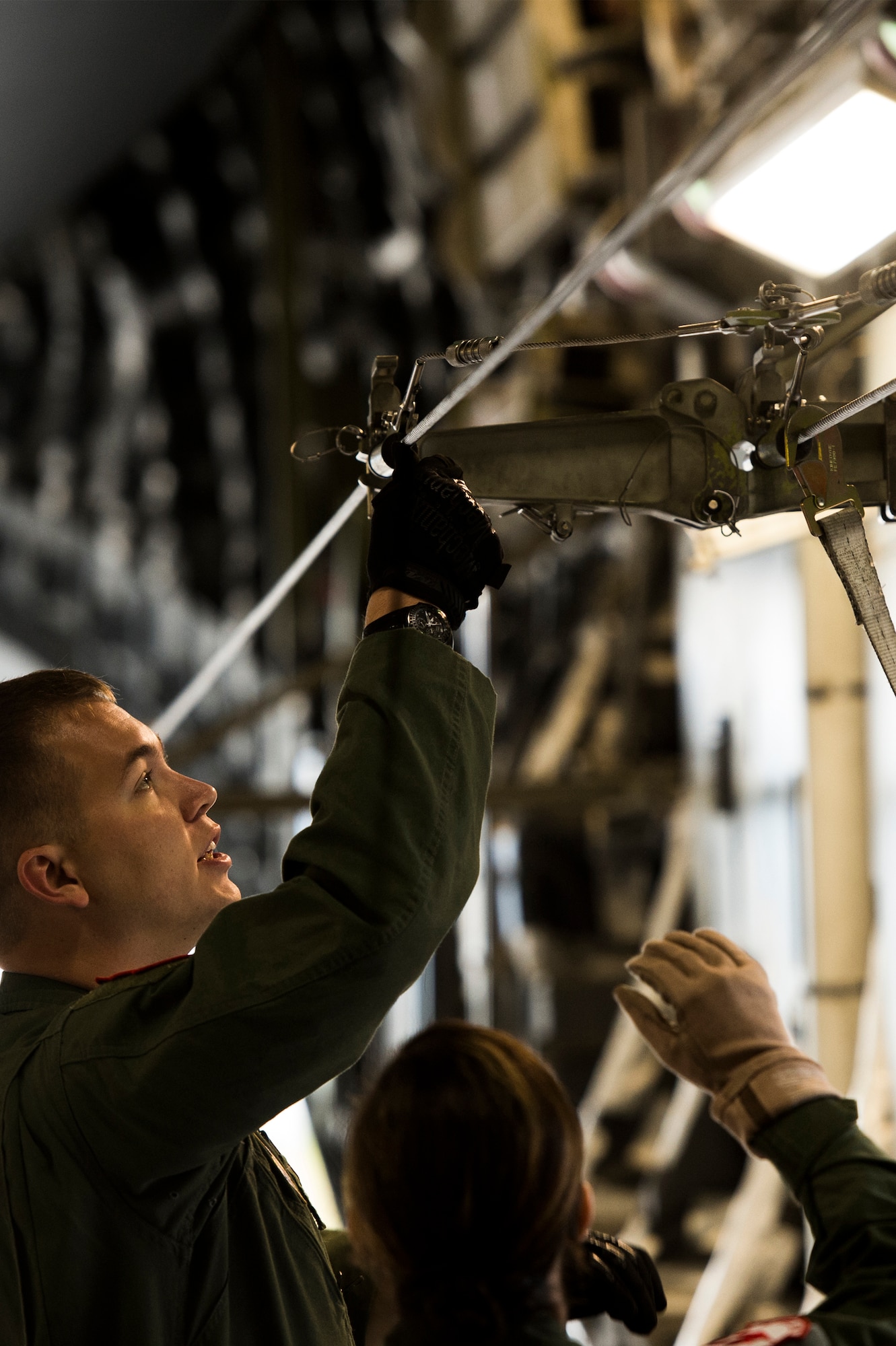 U.S. Air Force Staff Sgt. Neal Ylitalo and Airman 1st Class Cassie Lemus, 517th Airlift Squadron loadmasters, prepare for training with the U.S. Army 4-25 Airborne Brigade Combat Team inside a C-17 Globemaster III at Joint Base Elmendorf- Richardson, Alaska, Aug. 8, 2014. The 517th AS was showing support for the local Army jumpers by giving them a tour of the aircraft and answering questions. (U.S. Air Force photo by Staff Sgt. Stephany Richards/ Released)
