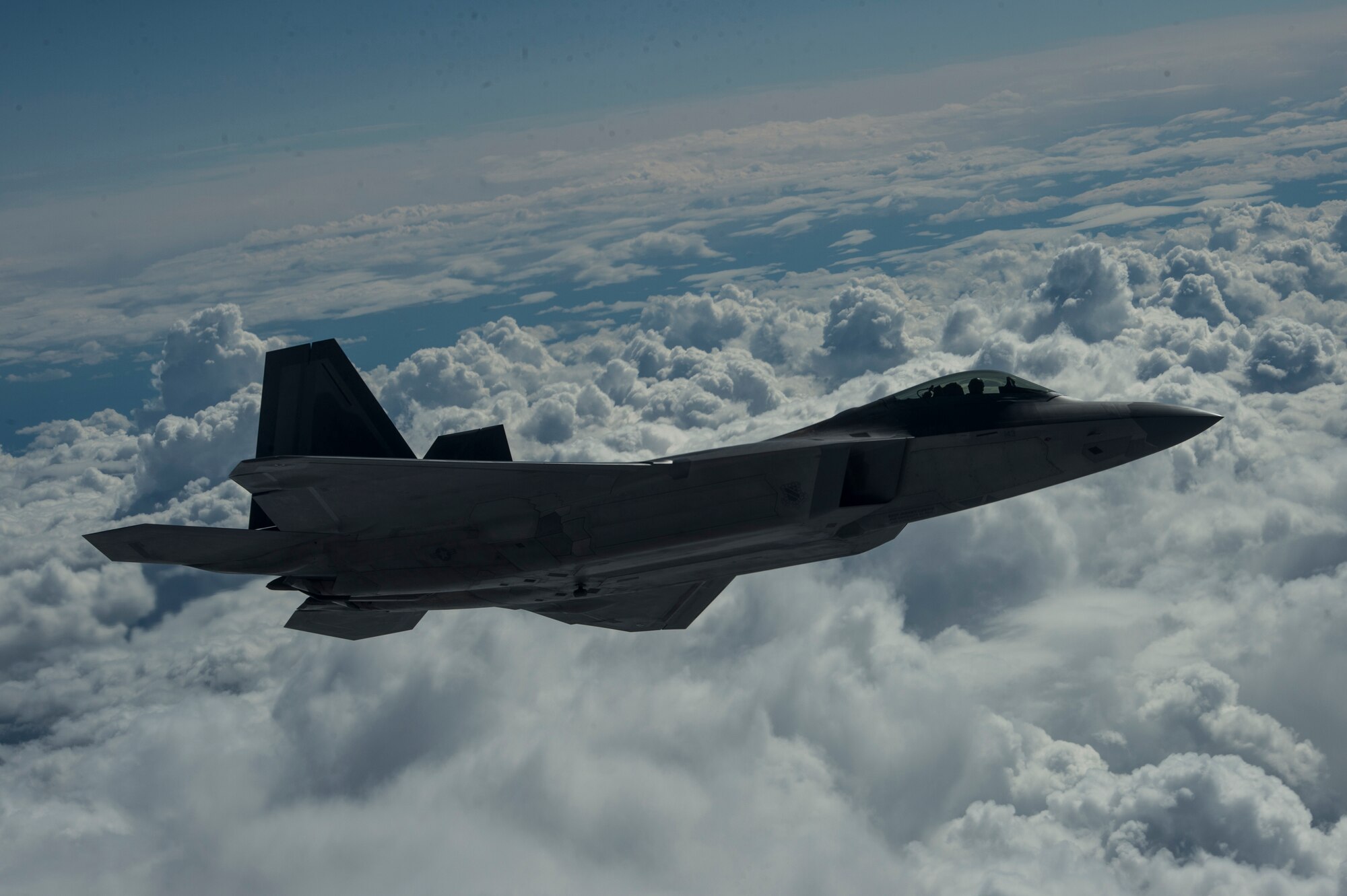 An F-22 Raptor from the U.S. Air Force 525th Fighter Squadron performs a refueling mission with a KC-135 Stratotanker from McConnell Air Force Base, Kan., outside of Joint Base Elmendorf-Richardson, Alaska, during a training mission, Aug. 7, 2014.  The F-22 is designed to project air dominance, rapidly and at great distances. (U.S. Air Force photo by Staff Sgt. Stephany Richards/ Released)