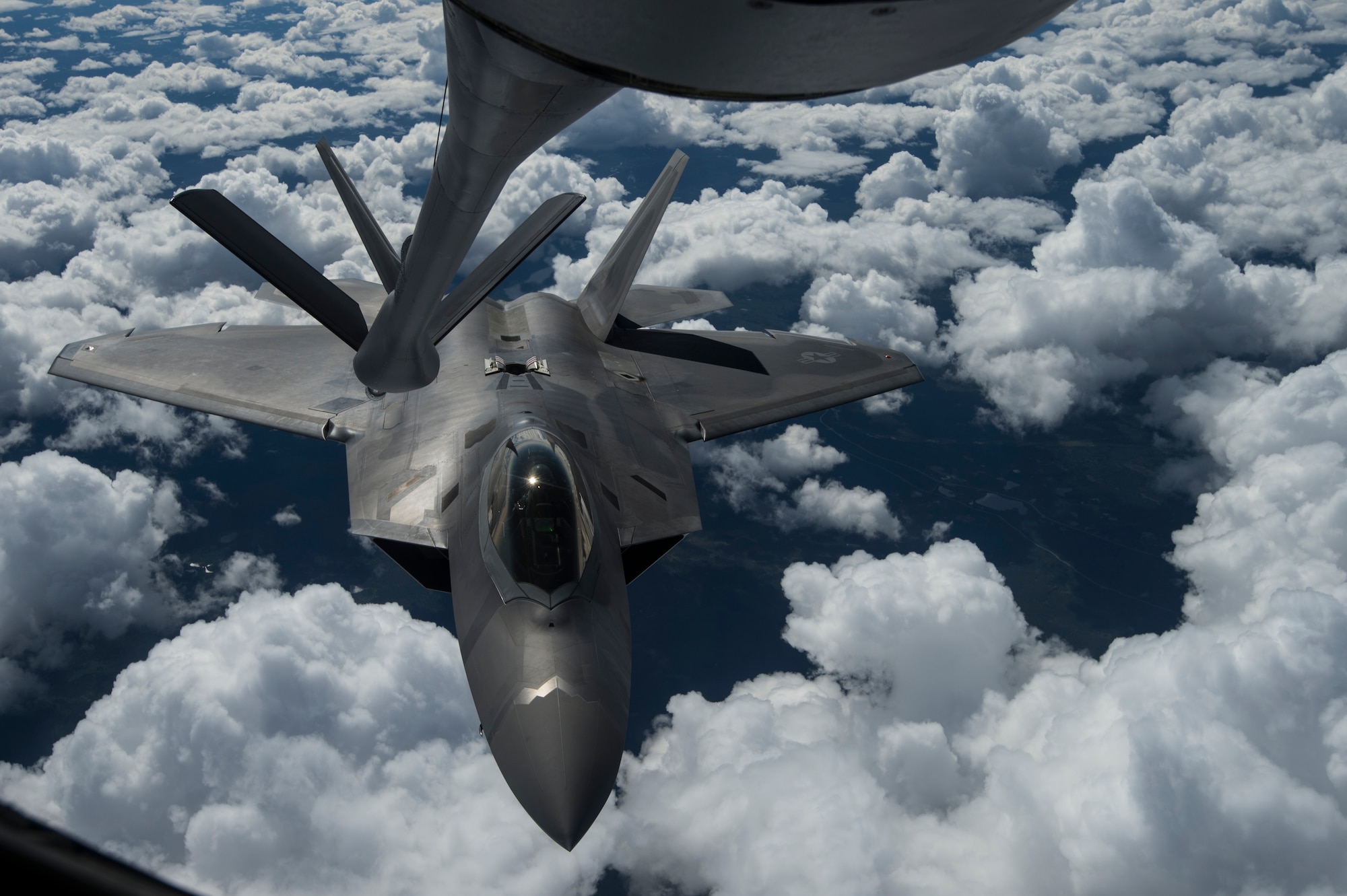 An F-22 Raptor from the U.S. Air Force 525th Fighter Squadron performs a refueling mission with a KC-135 Stratotanker from McConnell Air Force Base, Kan., outside of Joint Base Elmendorf-Richardson, Alaska, during a training mission, Aug. 7, 2014.  The F-22 is designed to project air dominance, rapidly and at great distances. (U.S. Air Force photo by Staff Sgt. Stephany Richards/ Released)