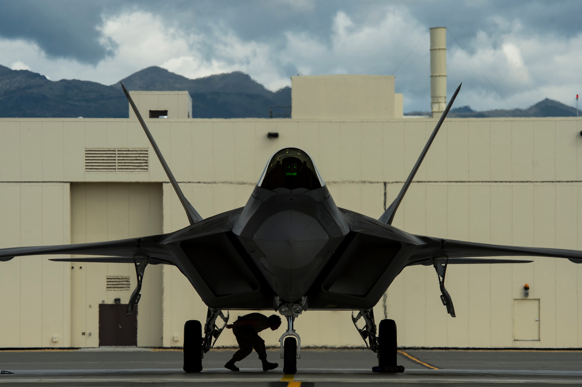 U.S. Air Force Airman 1st Class Joanna Waharton, 3rd Maintenance Squadron F-22 Raptor avionics, checks under an F-22 Raptor after a training mission at Joint Base Elmendorf-Richardson, Alaska, Aug. 6, 2014.  The F-22 is designed to project air dominance rapidly and at great distances. (U.S. Air Force photo by Staff Sgt. Stephany Richards/ Released)