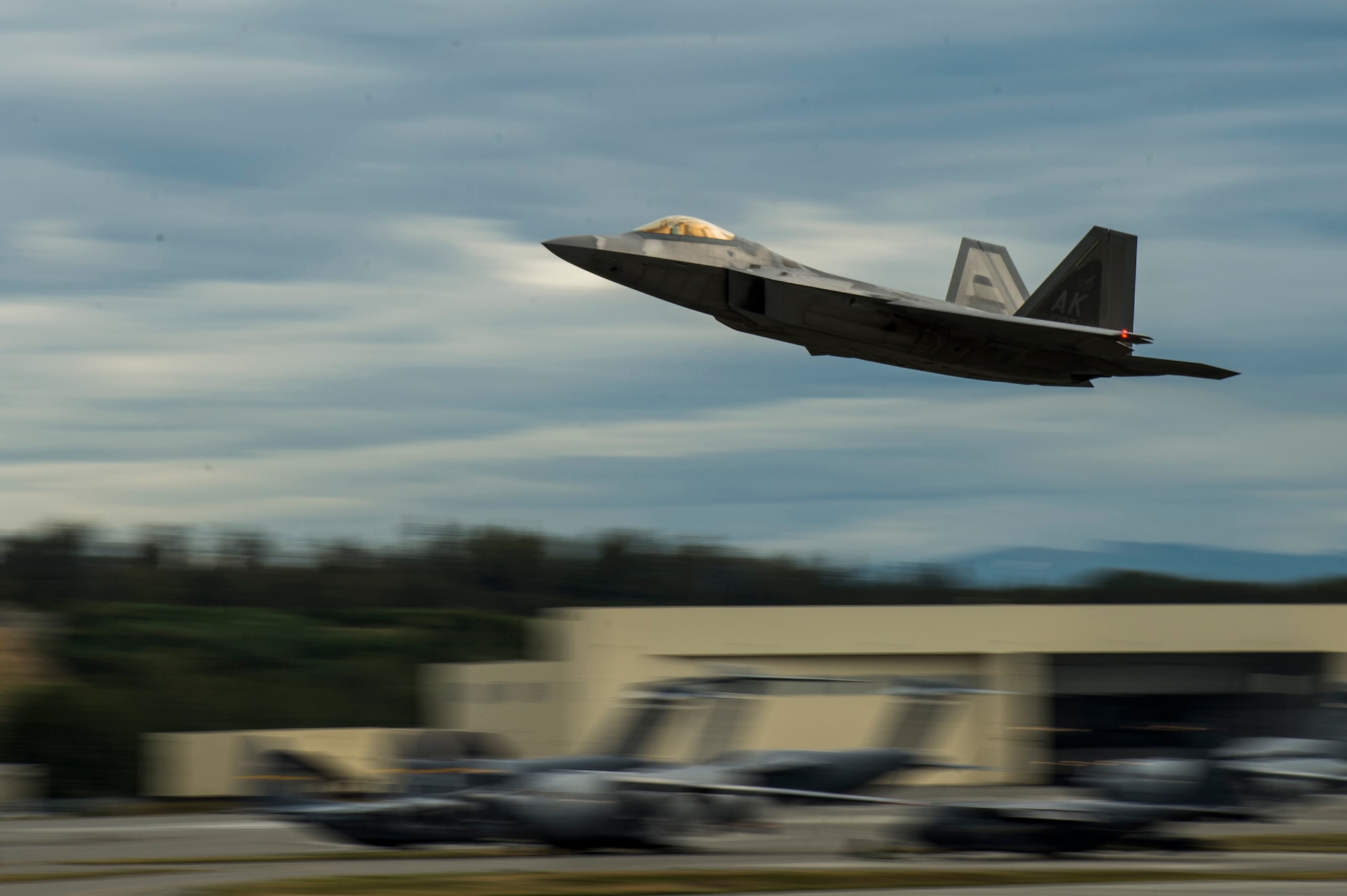 A U.S. Air Force F-22 Raptor from the 525th Fighter Squadron takes-off from the Joint Base Elmendorf-Richardson, Alaska, flightline during a training mission, Aug. 6, 2014.  The F-22 is designed to project air dominance rapidly and at great distances. (U.S. Air Force photo by Staff Sgt. Stephany Richards/ Released)