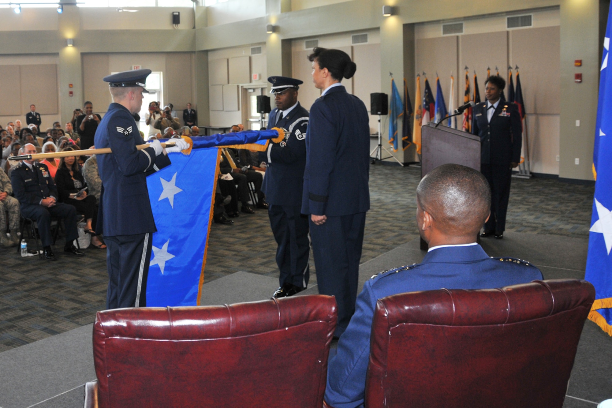 Members of the 94th Airlift Wing Honor Guard furl the one star flag and unfurl the two star flag during promotion and assumption of command ceremonies honoring Maj. Gen. Stayce D. Harris, 22nd Air Force commander, Aug. 9, 2014 at Dobbins Air Reserve Base, Ga. Harris will oversee 15,000 Reservists and 105 unit-equipped aircraft. She will have command supervision of the Reserve's air mobility operations and other vital mission sets. Reserve aircrews within 22nd Air Force fly a variety of missions to include aerial spraying, fire suppression, hurricane hunters to troop transport utilizing the C-130 Hercules. (U.S. Air Force photo/Staff Sgt. Jaclyn McDonald)