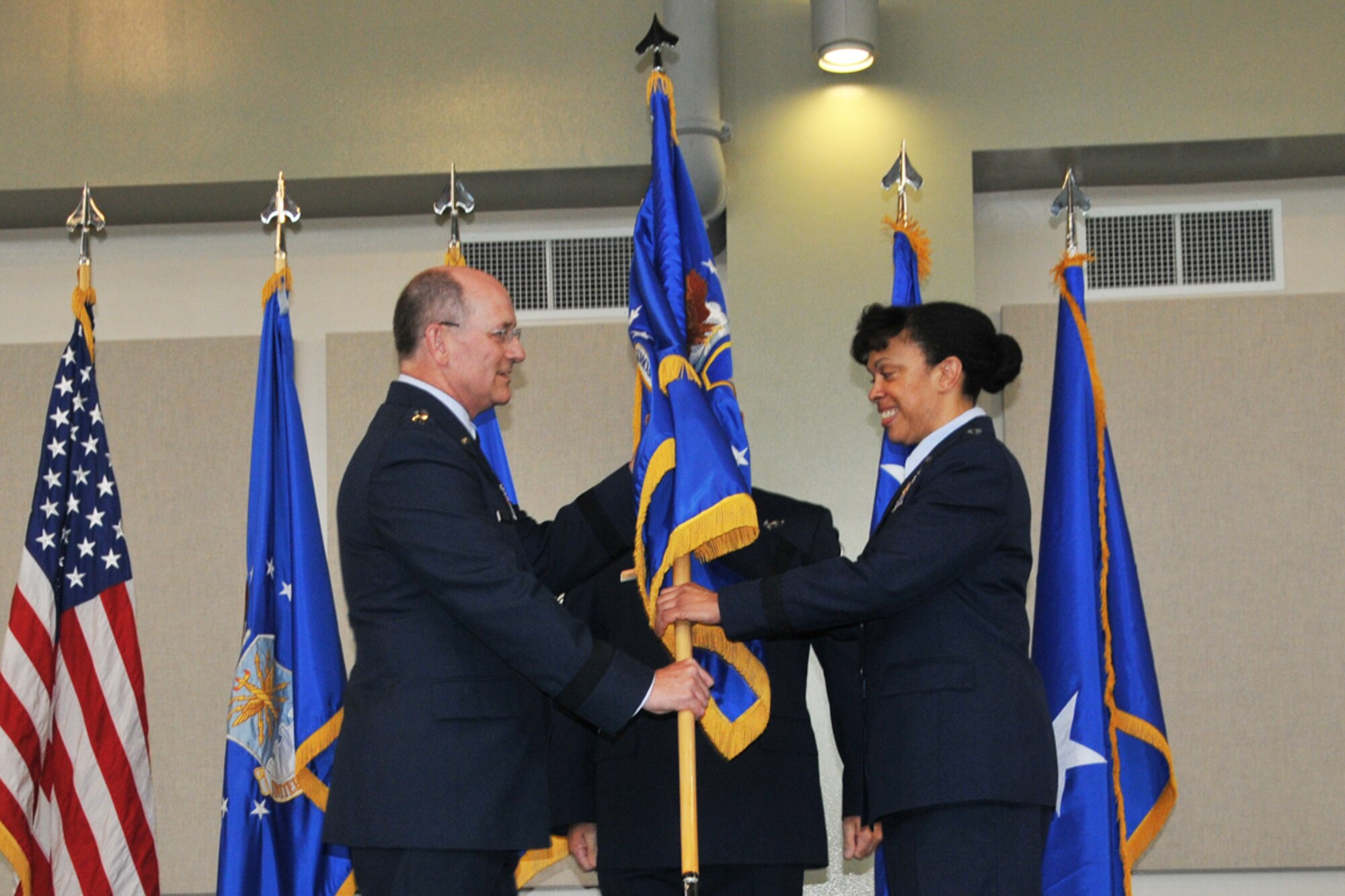 Lt. Gen. James “JJ” Jackson,  chief of Air Force Reserve, Headquarters U.S. Air Force, Washington, D.C., and commander, Air Force Reserve Command, passes the 22nd Air Force Flag to Maj. Gen. Stayce D. Harris, during an assumption of command ceremony Aug. 9, 2014 at Dobbins Air Reserve Base, Ga. Harris will oversee 15,000 Reservists and 105 unit-equipped aircraft. She will have command supervision of the Reserve's air mobility operations and other vital mission sets. Reserve aircrews within 22nd Air Force fly a variety of missions to include aerial spraying, fire suppression, hurricane hunters to troop transport utilizing the C-130 Hercules. (U.S. Air Force photo/Staff Sgt. Jaclyn McDonald)