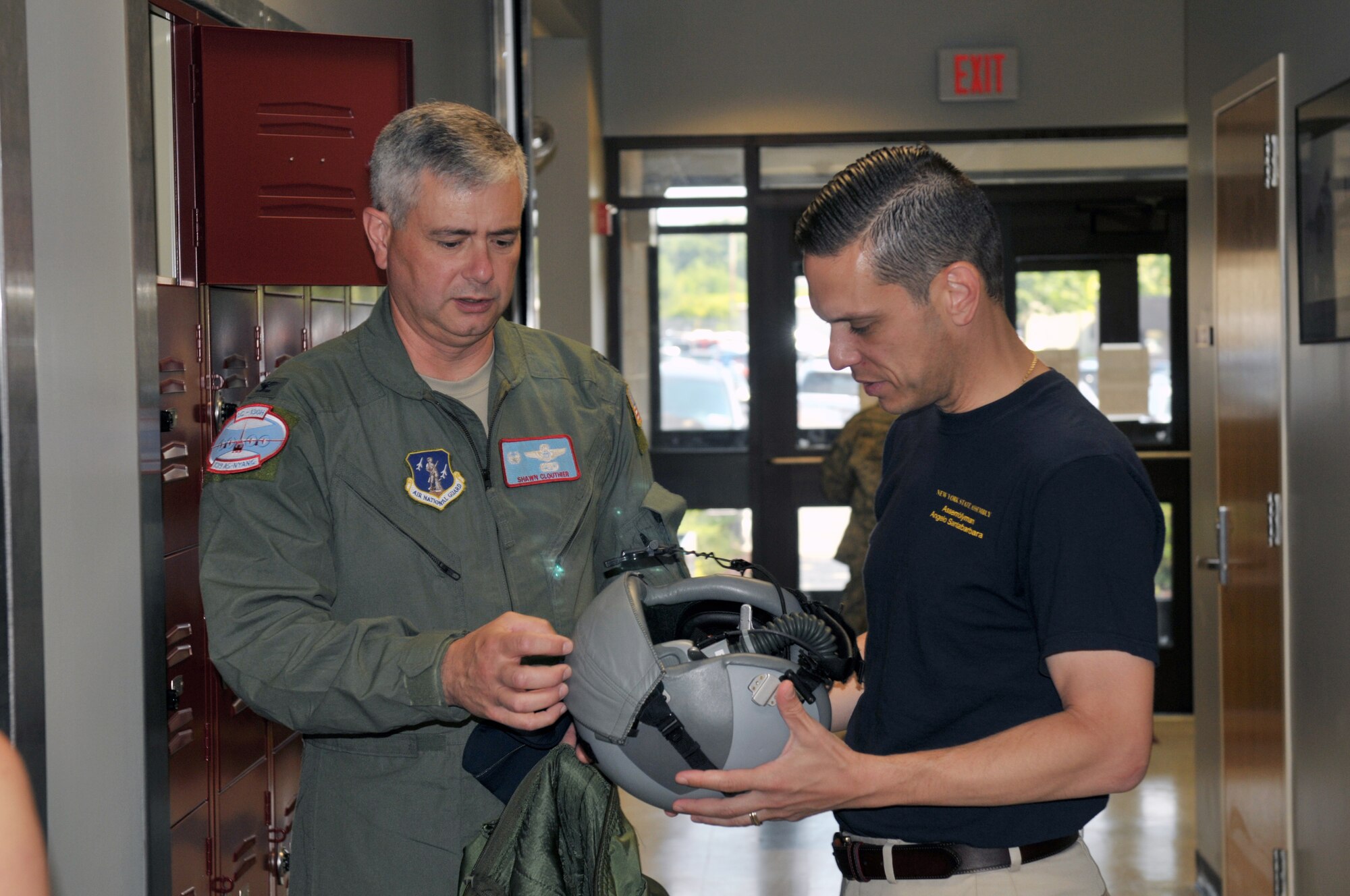 Col. Shawn Clouthier, 109th Airlift Wing commander, shows Assemblyman Angelo Santabarbara, 111th District, a pilot's helmet during a tour at Stratton Air National Guard Base, Scotia, New York, on Aug. 9, 2014. Santabarbara learned about the 109th's unique mission and also got to see the inside of an LC-130 Skibird. (U.S. Air National Guard photo by Staff Sgt. Benjamin German/Released)