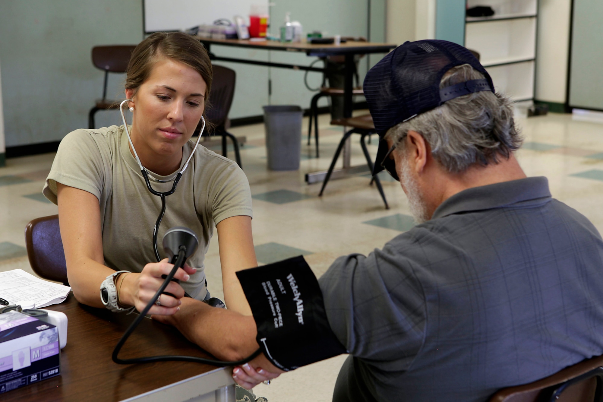 Senior Airman Jayci Cloutier, 434th Aero Medical Squadron aerospace medical services specialist, takes the blood pressure of a Kaua'i, Hawaii, resident June 18, 2014. Tropic Care 2014 provided real-world training in a joint civil-military environment while delivering world-class medical care to the people of Kaua'i, Hawai?i.  (Photo by U.S. Army SSG Daniel Bellamy/ Released)