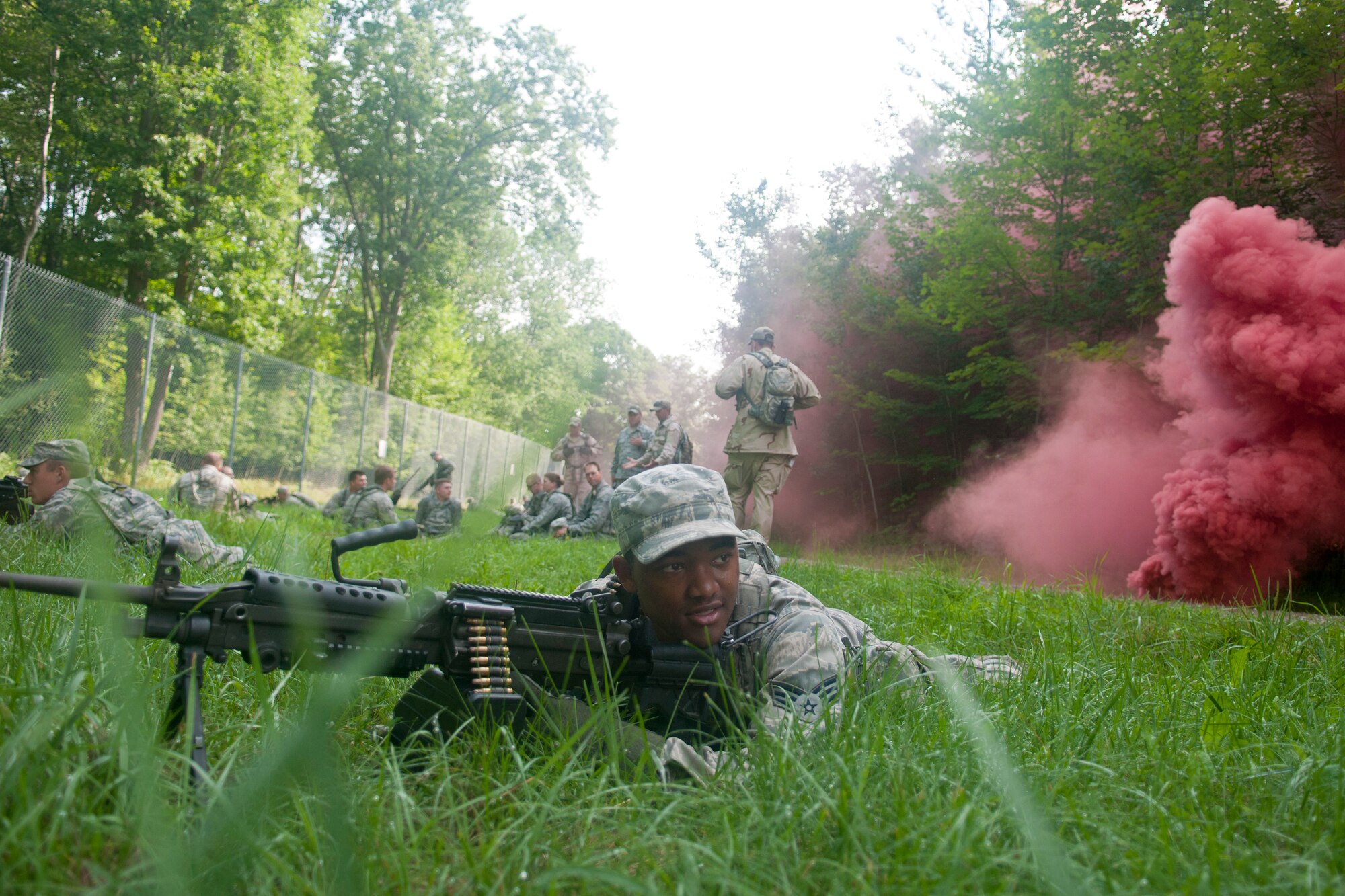 U.S. Air Force Senior Airman Elijah Managan, 121st Air Refueling Wing Security Forces Squadron, Rickenbacker Air National Guard Base, Ohio, simulates providing security while waiting for medical evacuation transport during the SFS annual training at the Alpena Combat Readiness Training Center, Mich., August 6, 2014. During the training, 121st SFS Airmen received instruction on mission planning, land navigation, building entry, casualty evacuation, and how to shoot, move and communicate. (U.S. Air National Guard photo by Airman 1st Class Wendy Kuhn/Released)