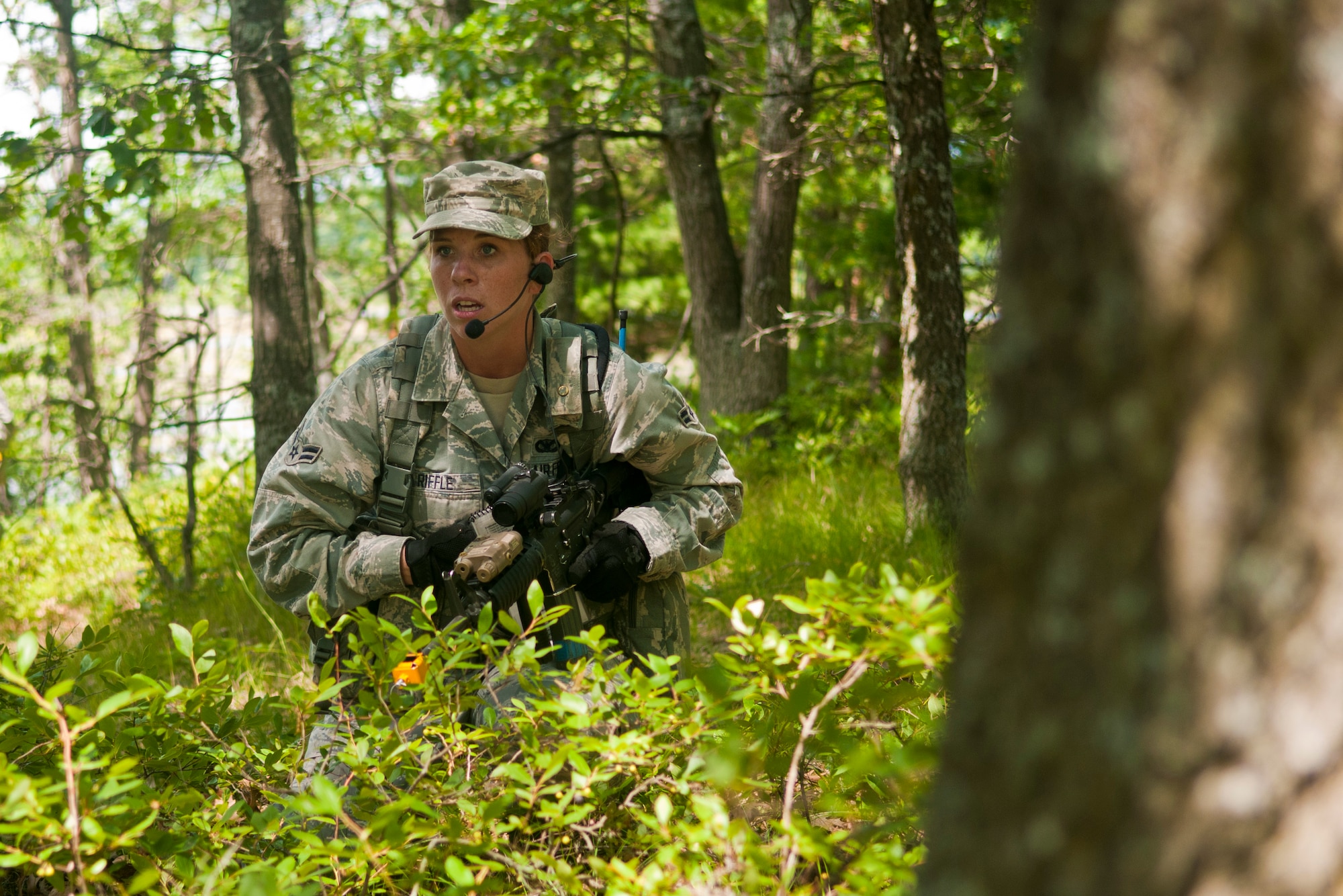 U.S. Air Force Airman 1st Class Heidi Riffle, 121st Air Refueling Wing Security Forces Squadron, Rickenbacker Air National Guard Base, Ohio, maneuvers through the woods during the SFS annual training at the Alpena Combat Readiness Training Center, Mich., August 5, 2014. During the training, 121st SFS Airmen received instruction on mission planning, land navigation, building entry, casualty evacuation, and how to shoot, move and communicate. (U.S. Air National Guard photo by Airman 1st Class Wendy Kuhn/Released)