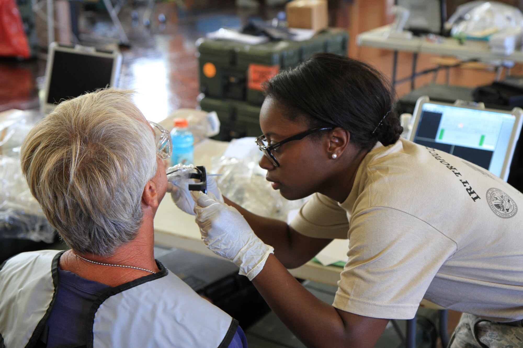 KAUAI, HAWAII – U.S. Air Force Airman 1st Class Jatoni White, Dental Assistant, 440th Medical Squadron, Pope Army Airfield, N.C., prepares a patient for a dental X-ray during Innovative Readiness Training exercise Tropic Care 2014. The humanitarian mission is part of a civil and joint military program to improve military readiness while simultaneously providing medical services to communities on the island of Kauai, Hawaii. (U.S. Army photo by Capt. Charles An/Released)