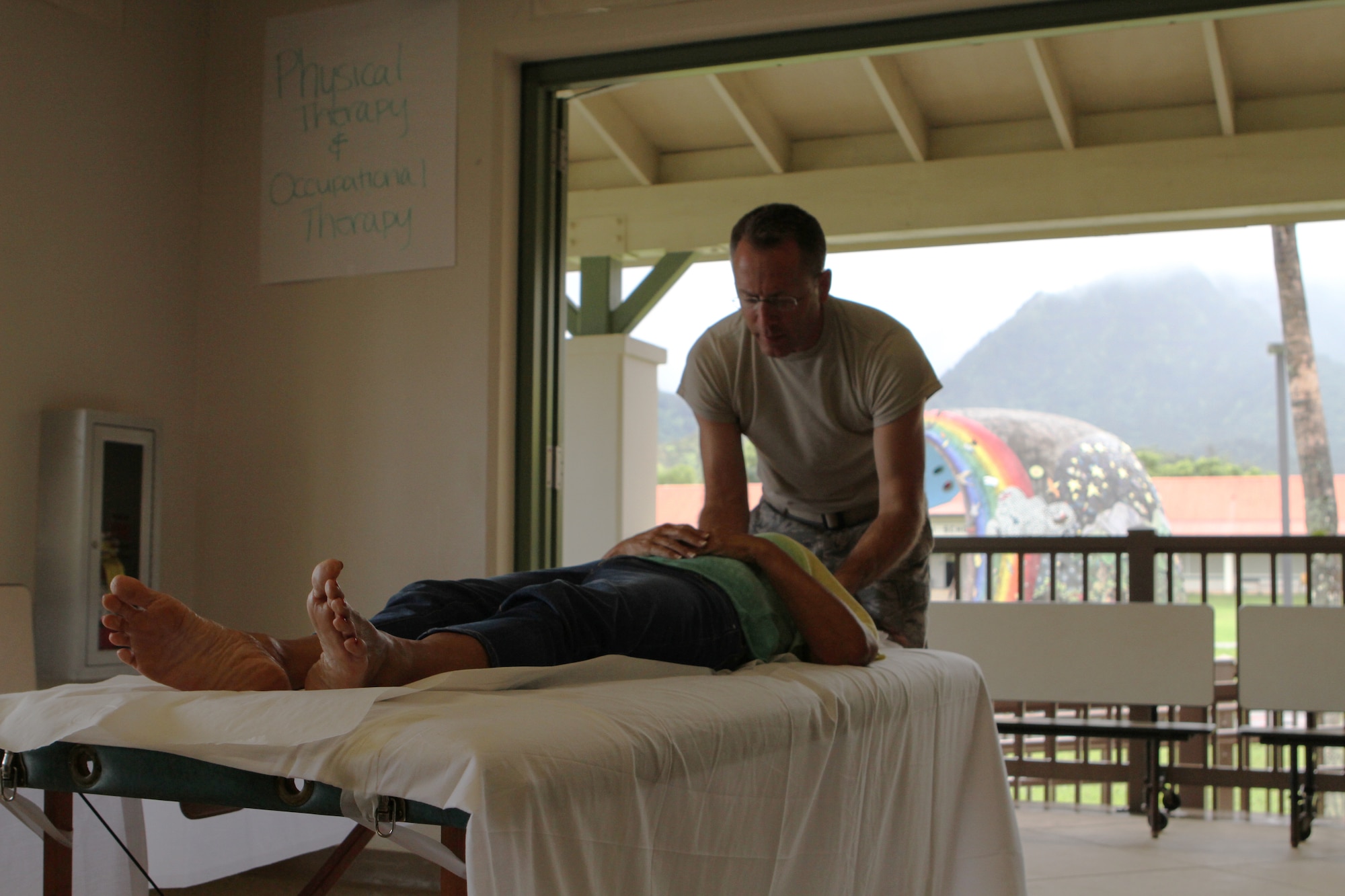 KAUAI, HAWAII - U.S. Air Force Maj. Eric James, a physical therapist with 440th Medical Squadron participating in Tropic Care 2014, makes a spinal manipulation for a local health care recipient at Hanalei Elementary School, June 16.  Tropic Care 2014, is an Innovative Readiness Training exercise, that provides real-world training in a joint civil-military environment while delivering world class medical care to the people of Kauai, Hawaii. (U.S. Army photo by Sergeant First Class Sean A. Foley/Released)