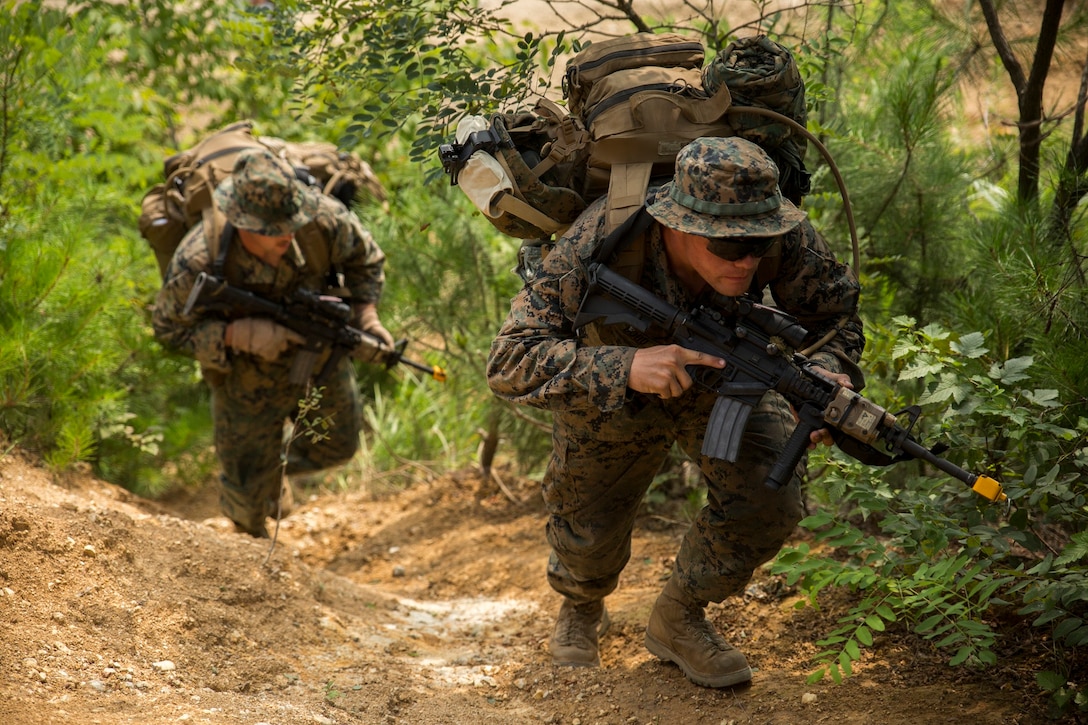 U.S. Marine Lance Cpl. Dakota W. Dodd, right, hikes up a hill while patrolling July 22 during Korean Marine Exchange Program 14-12 at the 1st Republic of Korea Marine Division Base, Pohang, South Korea. KMEP is a series of regularly scheduled bilateral training exercises used to enhance interoperability and increase familiarization with the Korean Peninsula. The patrol training event involved a movement to contact and a transition to defense between opposing ROK and U.S. Marine forces. Dodd is a light armored vehicle crewman with Company B, 3rd Light Armored Reconnaissance Battalion, currently assigned to Combat Assault Battalion, 3rd Marine Division, III Marine Expeditionary Force, under the unit deployment program. 