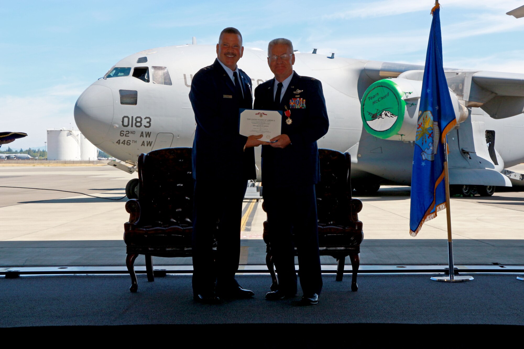 Maj. Gen. Mark A. Kyle presents a Legion of Merit certificate to Col. (Ret.) Bruce Bowers, former Commander of the 446th Airlift Wing, during his retirement ceremony at Hangar 9 here Aug. 9, 2014. The award recognizes Bowers for his consistently loyal and meritorious service. As the major general said, Bruce is the type of Airman that he aspires to be. (U.S. Air Force Reserve photo by Senior Airman Madelyn McCullough)