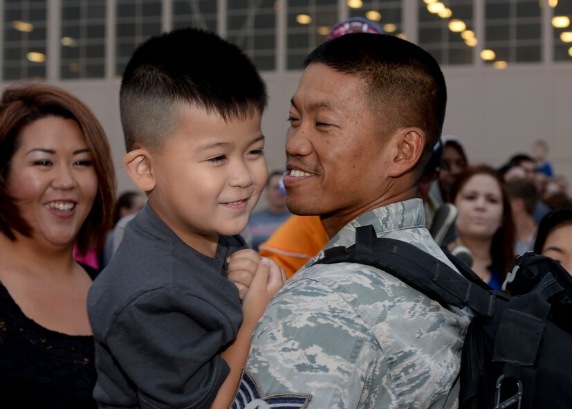 Staff Sgt. Mark Duque, 28th Aircraft Maintenance Squadron B-1 bomber crew chief, is welcomed home by his family from a deployment to Southwest Asia at Ellsworth Air Force Base, S.D., Aug. 10, 2014. Duque was one of more than 350 Airmen who served more than six-months in support of Operation Enduring Freedom. (U.S. Air Force photo by Senior Airman Anania Tekurio/Released)
