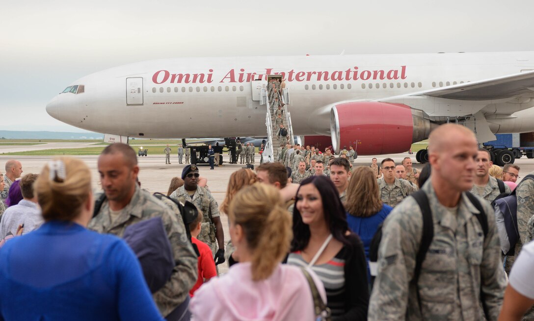 Family and friends of Ellsworth Airmen welcome home deployed Airmen at Ellsworth Air Force Base, S.D., Aug. 10, 2014. Ellsworth Airmen provided support to combatant commanders in the U.S. Central Command area of responsibility during a six-month deployment to Southwest Asia. (U.S. Air Force photo by Senior Airman Zachary Hada/Released)