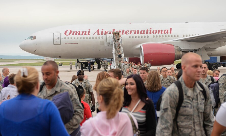 Family and friends of Ellsworth Airmen welcome home deployed Airmen at Ellsworth Air Force Base, S.D., Aug. 10, 2014. Ellsworth Airmen provided support to combatant commanders in the U.S. Central Command area of responsibility during a six-month deployment to Southwest Asia. (U.S. Air Force photo by Senior Airman Zachary Hada/Released)