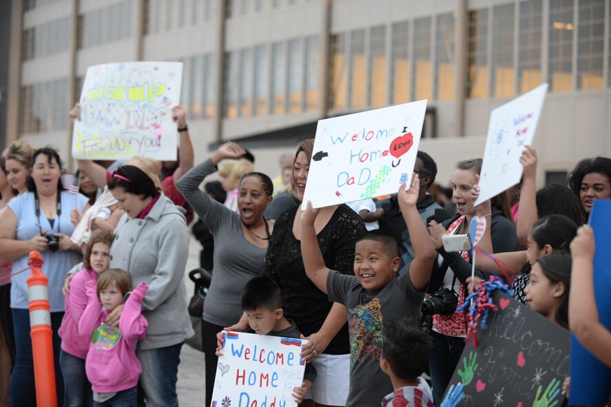 Family and friends of Ellsworth Airmen celebrate their return from a deployment to Southwest Asia at Ellsworth Air Force Base, S.D., Aug. 10, 2014. The Airmen were deployed more than six months in support of Operation Enduring Freedom in the U.S. Central Command area of responsibility. (U.S. Air Force photo by Senior Airman Zachary Hada/Released)