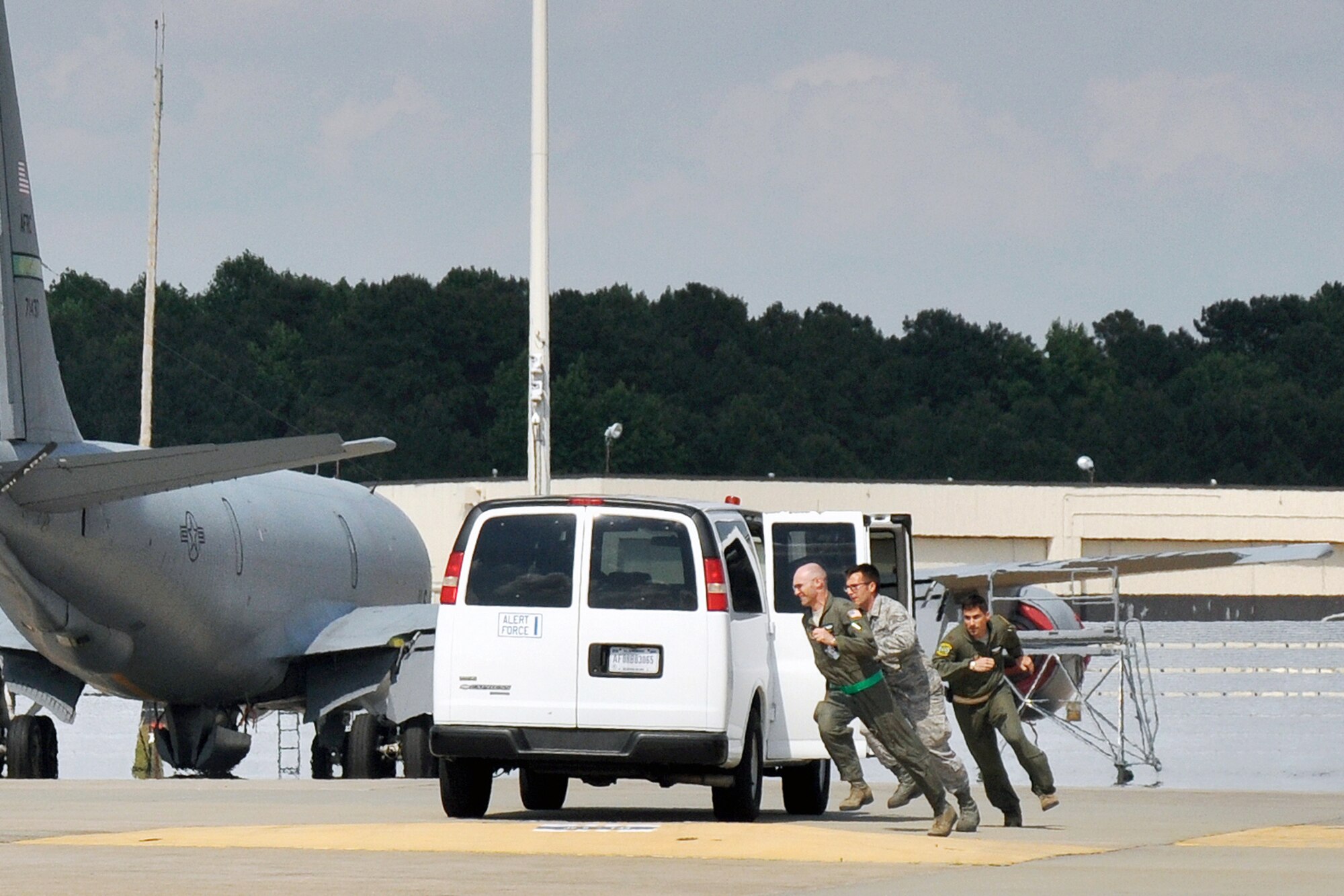 Maj. Brad Percy, Staff Sgt. Jeremy Volz and Maj. Kris Person, 916th Air Refueling Wing, Seymour Johnson Air Force Base, North Carolina, rush to board a KC-135 Stratotanker aircraft during Exercise Razor Sharp, June 2014. (USAF photo by SSgt. Alan Abernethy, 916ARW/PA)