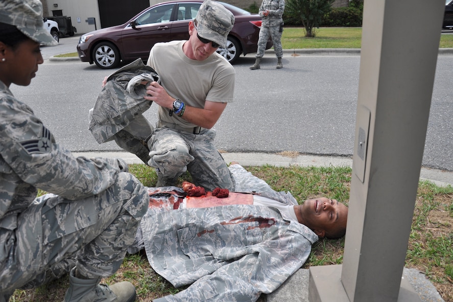 916th Air Refueling Wing Airmen care for Senior Airman Emanuel Carraway, 916th Aerospace Medicine Squadron, as he plays the role of an injured victim for a Self-Aid Buddy Care and medical skills assessment during Exercise Razor Sharp, June 2014. (USAF photo by SSgt. Alan Abernethy, 916ARW/PA)