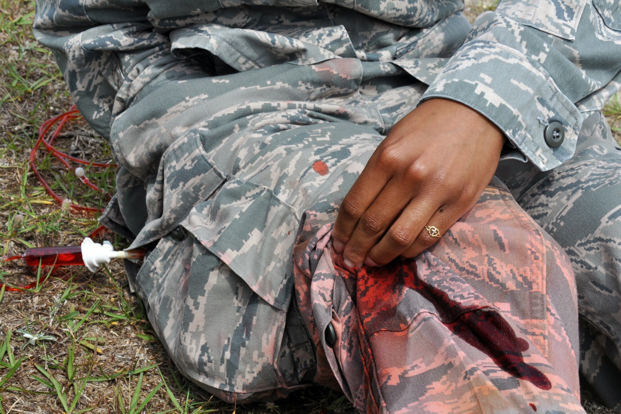 An Airman from the 916th Air Refueling Wing, Seymour Johnson Air Force Base, North Carolina, plays the role of an injured victim for a Self-Aid Buddy Care skills assessment during Exercise Razor Sharp, June 2014. (USAF photo by SSgt. Alan Abernethy, 916ARW/PA)