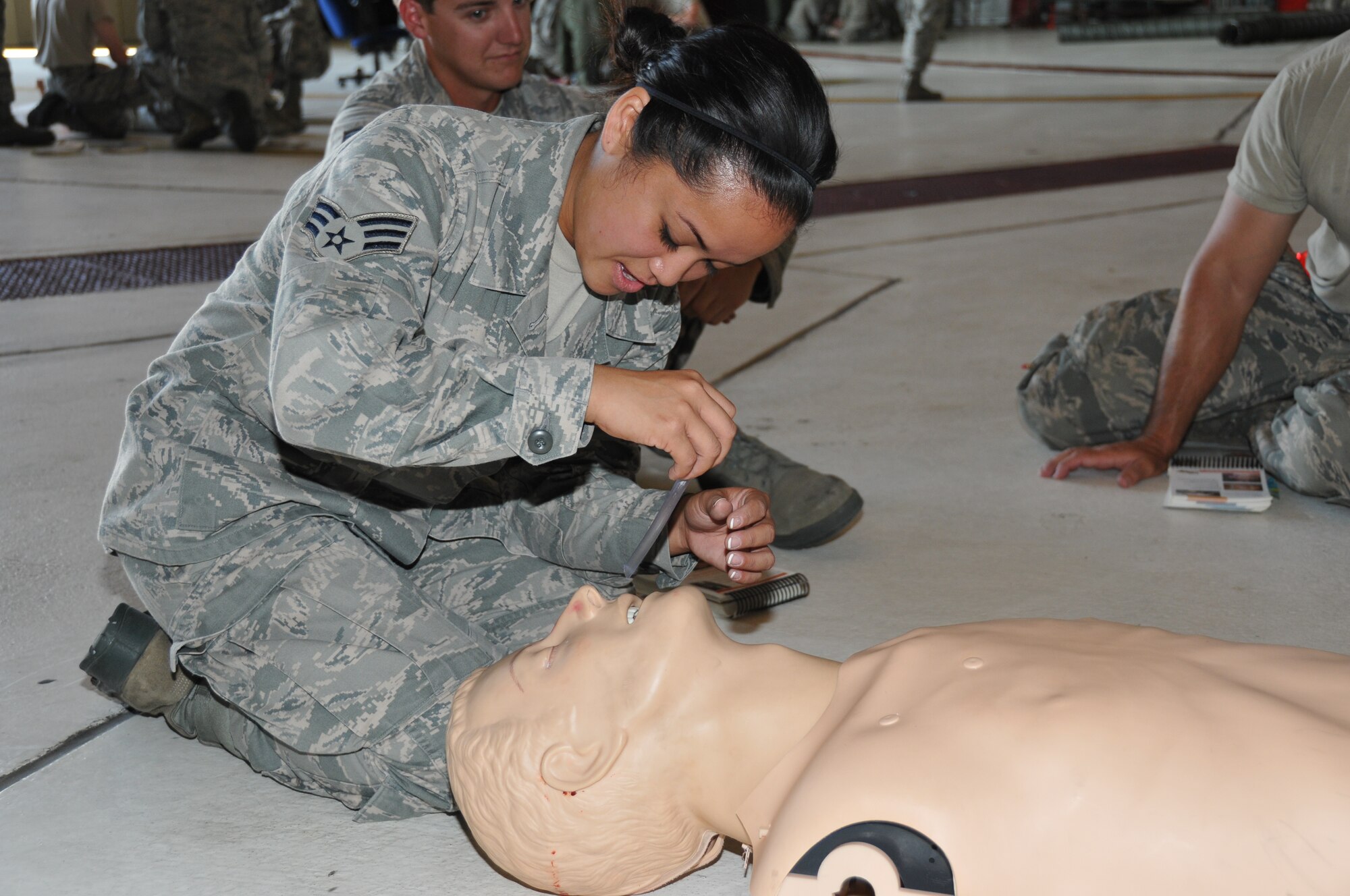 Senior Airman Jennilyn Jiro, 916th Aircraft Maintenance Squadron, Seymour Johnson Air Force Base, North Carolina, participates in a Self-Aid Buddy Care skills assessment during Exercise Razor Sharp, June 2014. (USAF photo by SSgt. Alan Abernethy, 916ARW/PA)