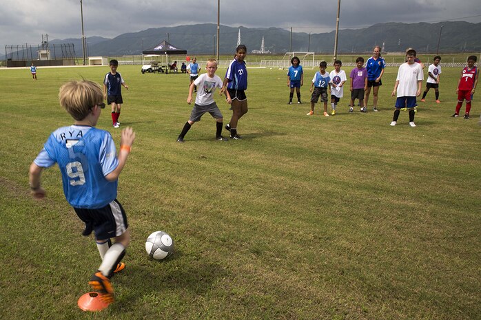Participants of the Southern California Seahorse Soccer Club soccer camp take part in a scrimmage at Penny Lake fields aboard Marine Corps Air Station Iwakuni, July 24, 2014. The soccer camp was hosted by the Seahorses in association with Marine Corps Community Services to provide Iwakuni youth the opportunity to improve their soccer skills.