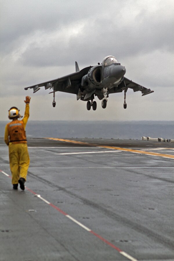 An AV-8B Harrier Jump Jet from Marine Medium Tiltrotor Squadron 365 (Reinforced), 24th Marine Expeditionary Unit, prepares to land aboard the USS Iwo Jima off the coast of North Carolina, Aug. 9, 2014. The 24th MEU is taking part in Amphibious Squadron/Marine Expeditionary Unit Integration, or PMINT, the 24th MEU’s second major pre-deployment training exercise. PMINT is designed to bring Marines and Sailors from the 24th MEU and Amphibious Squadron 8 together for the first time aboard the ships of the Iwo Jima Amphibious Ready Group. (U.S. Marine Corps photo by Sgt. Devin Nichols)