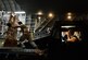Staff Sgt. Daniel Leavindofske, 8th Expeditionary Air Mobility Squadron ramp team chief and Senior Airman David Babcock, air transportation journeyman, assist with loading 28,224 halal meals to a C-17 Globemaster III for a humanitarian airdrop mission over Iraq, Aug. 9, 2014, at a base in the U.S. Central Command area of responsibility. The humanitarian aid includes bottled water and food which was delivered to displaced citizens in the vicinity of Sinjar, Iraq. (U.S. Air Force photo by Staff Sgt. Vernon Young Jr.)