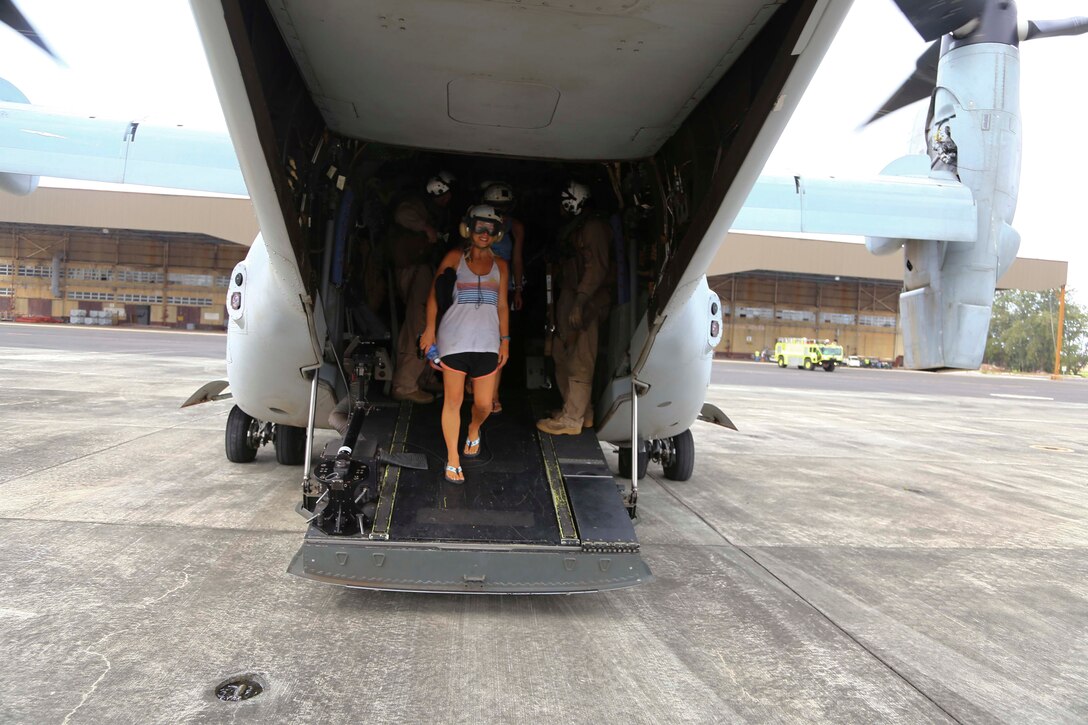 National Oceanic and Atmospheric Administration (NOAA) researchers depart  an MV-22B Osprey from Marine Medium Tiltrotor Squadron 163 (Reinforced), 11th Marine Expeditionary Unit, after arriving at Midway Atoll during the MEU’s WESTPAC 14-2 deployment Aug. 8, 2014. Marines and sailors from the 11th MEU and Makin Island Amphibious Ready Group team recovered 11 personnel from three isolated islands more than 900 nautical miles northwest of Hawaii and directly in the path of Hurricane Iselle. MEU aircraft transported the researchers to Midway Atoll where they could seek shelter from the storm. (U.S. Marine Corps photo by Lance Cpl. Laura Y. Raga/Released)