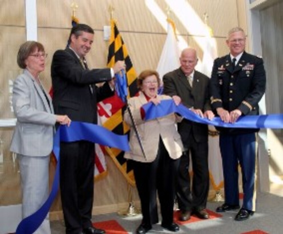 Standing in front of the Maryland flag, Sen. Barbara Mikulski cuts the ribbon on the newly expanded Dr. Edward J. Poziomek Advanced Chemistry Laboratory at Aberdeen Proving Ground on Aug. 5. Through funding secured by the Maryland congressional delegation, the U.S. Army Corps of Engineers, Baltimore District, added an 11,500 foot chemistry wing and a 14,500 square foot administrative area. From left: Suzanne Milchling, Edgewood Chemical Biological Center; Dale Ormond, U.S. Army Research, Development and Engineering Command; Sen. Mikulski; Doug Bryce, Joint Program Executive Office - Chemical Biological Defense; and Col. Trey Jordan, U.S. Army Corps of Engineers. 