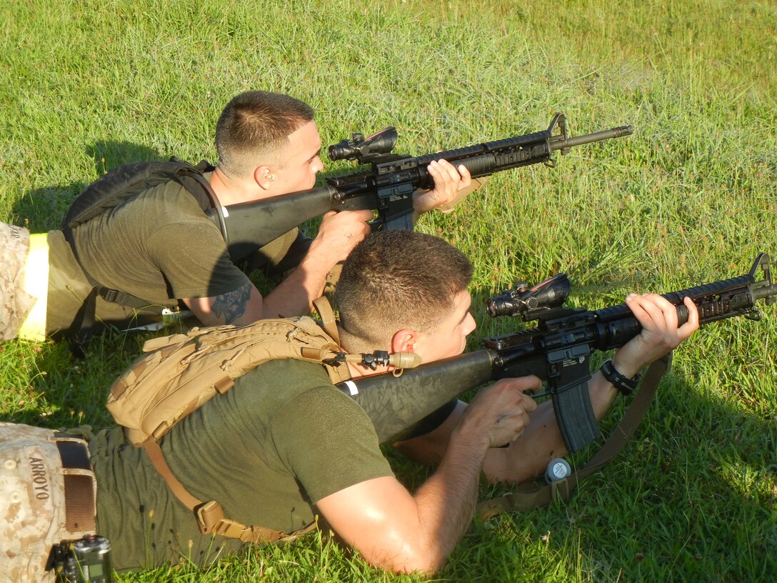 Marines from The Basic School, above, take aim down range while standing during the 2nd Annual Montford Point Biathlon on July 25.