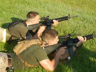 Marines from The Basic School, above, take aim down range while standing during the 2nd Annual Montford Point Biathlon on July 25.
