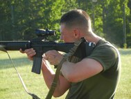 Marines from The Basic School, above, take aim down range while standing during the 2nd Annual Montford Point Biathlon on July 25.