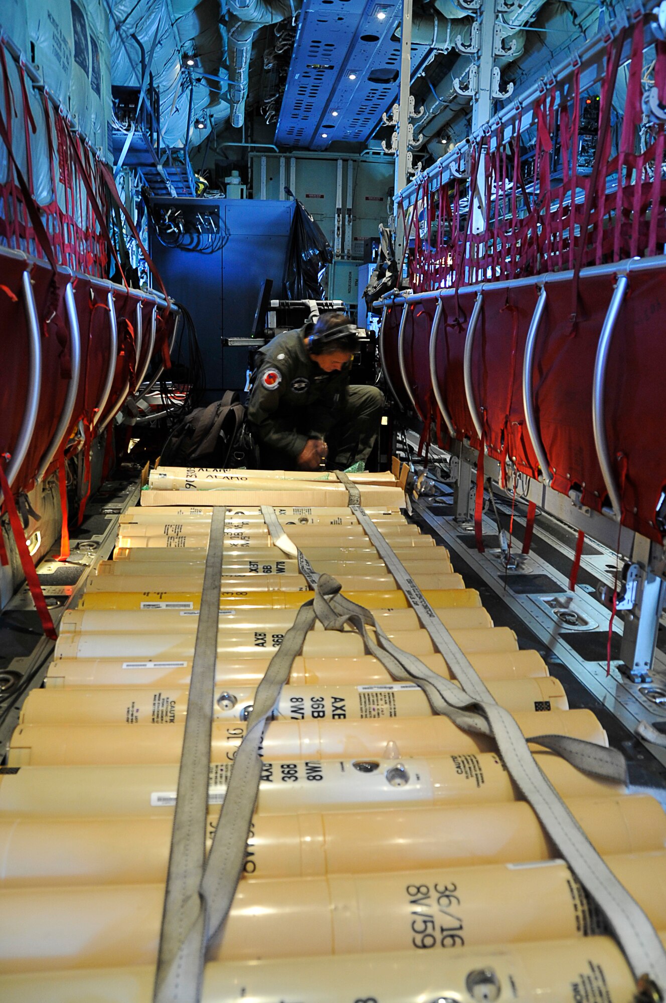 Navy Cmdr. Elizabeth Sanabia, U.S. Naval Academy researcher, straps down Airborne/Air Expendable Bathythermograph , orABXT, deep water buoys for a flight into Hurricane Iselle off the coast of Hawaii Aug. 6, 2014. Sanabia flew with the Air Force Reserve’s 53rd Weather Reconnaissance Squadron into Hurricane Iselle in order to collect salinity and water temperature for research. The 53rd WRS "Hurricane Hunters" aircrew and 403rd Wing maintenance personnel deployed to Joint Base Pearl Harbor-Hickam, Hawaii to fly storm missions into Hurricanes Iselle and Julio. (U.S. Air Force photo/Master Sgt. Jessica Kendziorek)