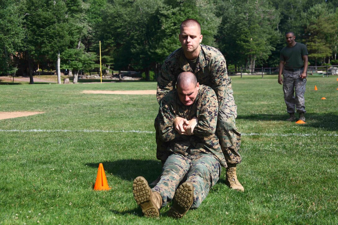 Staff Sgt. Andrew Lynch, a recruiter with Prior Service Recruiting - 1, drags his buddy during the maneuver under fire portion of the Combat Fitness Test, Aug. 5 during the PSR-1 Conference. “The CFT is broken down into three separate parts the 880 run, ammo cam lifts and the maneuver under fire,” said Lynch. “These parts test speed, endurance and upper body strength.”  (U.S. Marine Corps photo by Lance Cpl. Brandon Thomas)