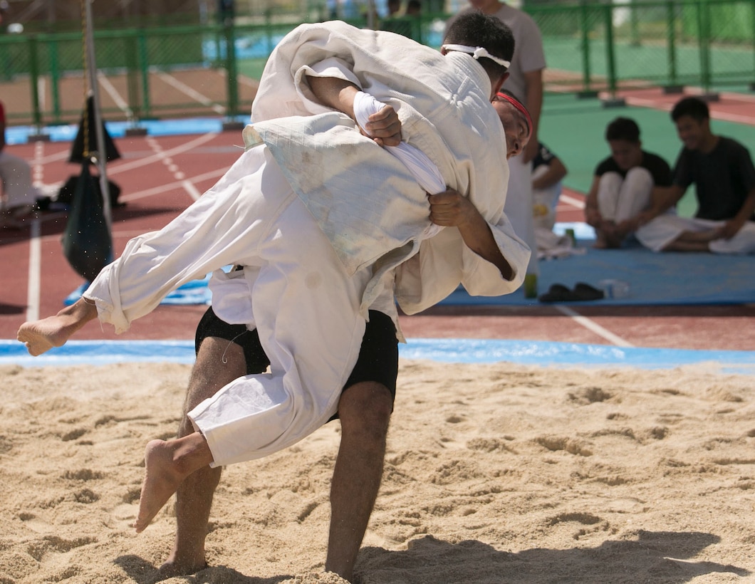 Sgt. Daniel J. Keil, black shorts, picks up his opponent in attempted takedown during the 35th annual Okinawa Island-Wide Sumo Tournament July 26 at the Kin Town Athletic Field. Keil’s main objective during the tournament was to use any method to try to pin his opponent’s back on the ground without removing his hands from his opponent’s belt. Keil is a San Jose, California, native and imagery analyst specialist with 3rd Intelligence Battalion, III Marine Expeditionary Force Headquarters Group, III MEF. (U.S. Marine Corps photo by Lance Cpl. Tyler Ngiraswei/Released)