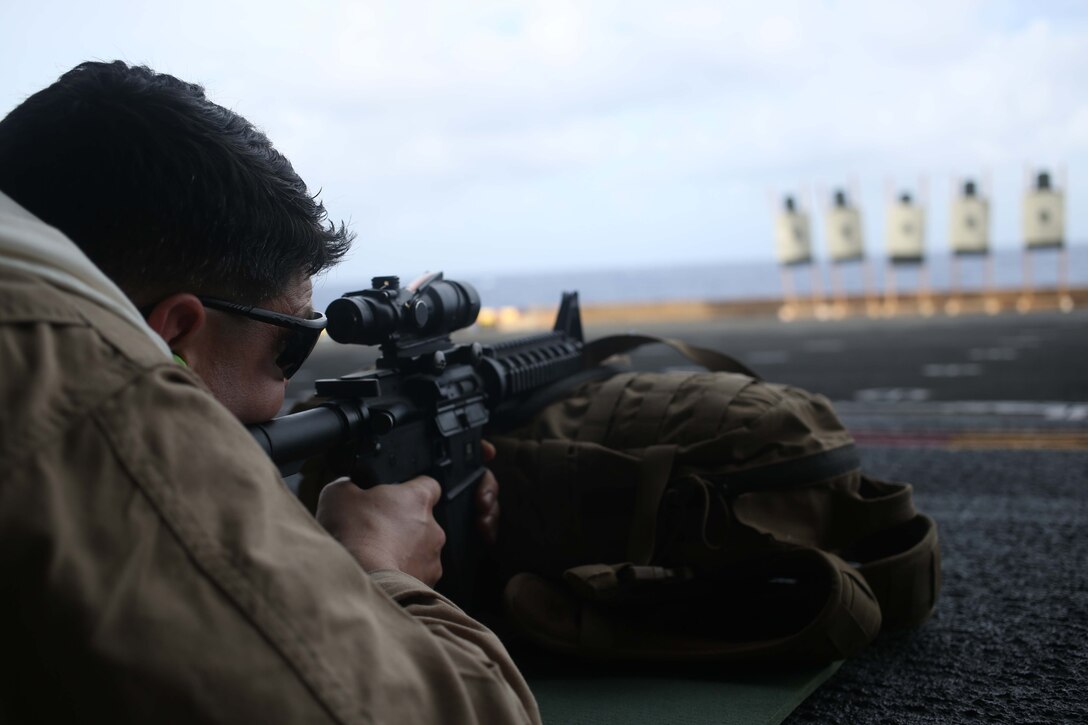A Marine with Marine Medium Tiltrotor Squadron 163 (Reinforced), 11th Marine Expeditionary Unit, battle zeroes his weapon during the 11th MEU’s WESTPAC 14-2 deployment August 6, 2014. The 11th MEU and Makin Island Amphibious Ready Group are deployed as a sea-based, expeditionary crisis response force capable of conducting amphibious missions across the full range of military operations.