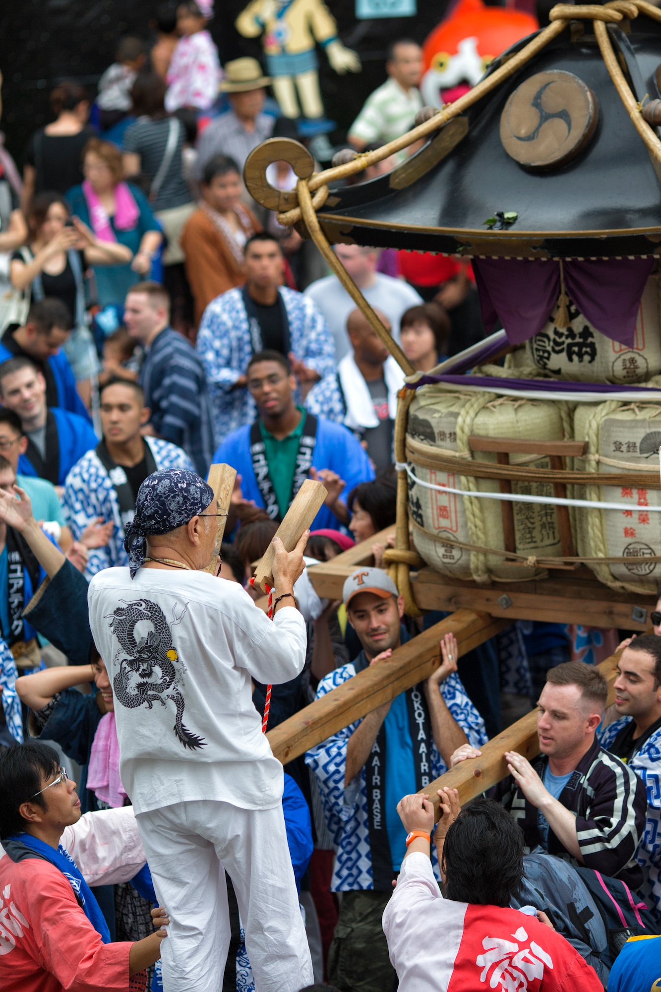 Japanese and American mikoshi shrine carriers chant and clap during the 64th annual Fussa Tanabata Festival, Fussa city, Japan, Aug. 8, 2014. The festival gives Yokota members an opportunity to meet and build friendships with the local community while experiencing Japanese culture. (U.S. Air Force photo by Osakabe Yasuo/Relased)