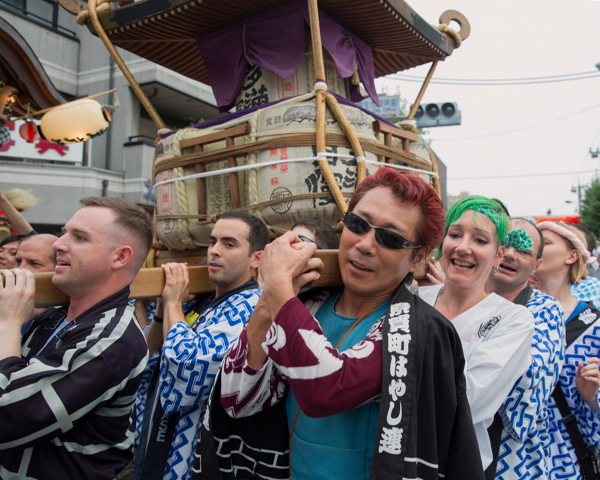 Airmen from Yokota Air Base help carry a mikoshi shrine with their Japanese friends during the Fussa Tanabata Festival in Fussa City, Japan, Aug. 8, 2014. The festival gives Yokota members an opportunity to meet and build friendships with the local community while experiencing Japanese culture. (U.S. Air Force photo by Osakabe Yasuo/Released)
