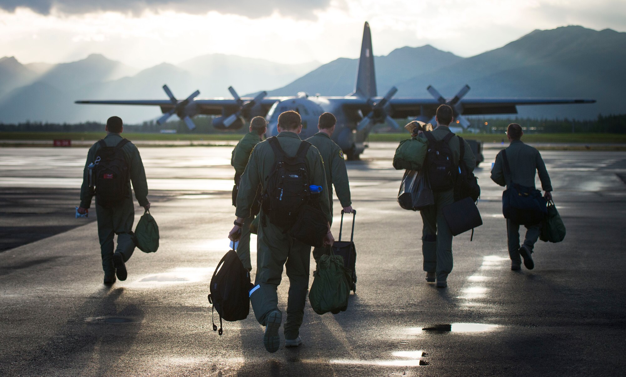 Members from the 36th Airlift Squadron step to their aircraft during the first day of Exercise Red Flag Aug. 11, 2014, Joint Base Elmendorf-Richardson, Alaska. Red Flag is an exercise that provides joint offensive counter-air, interdiction, close air support, and large force employment training in a simulated combat environment. (U.S. Air Force photo by Staff Sgt. Chad C. Strohmeyer/Released)