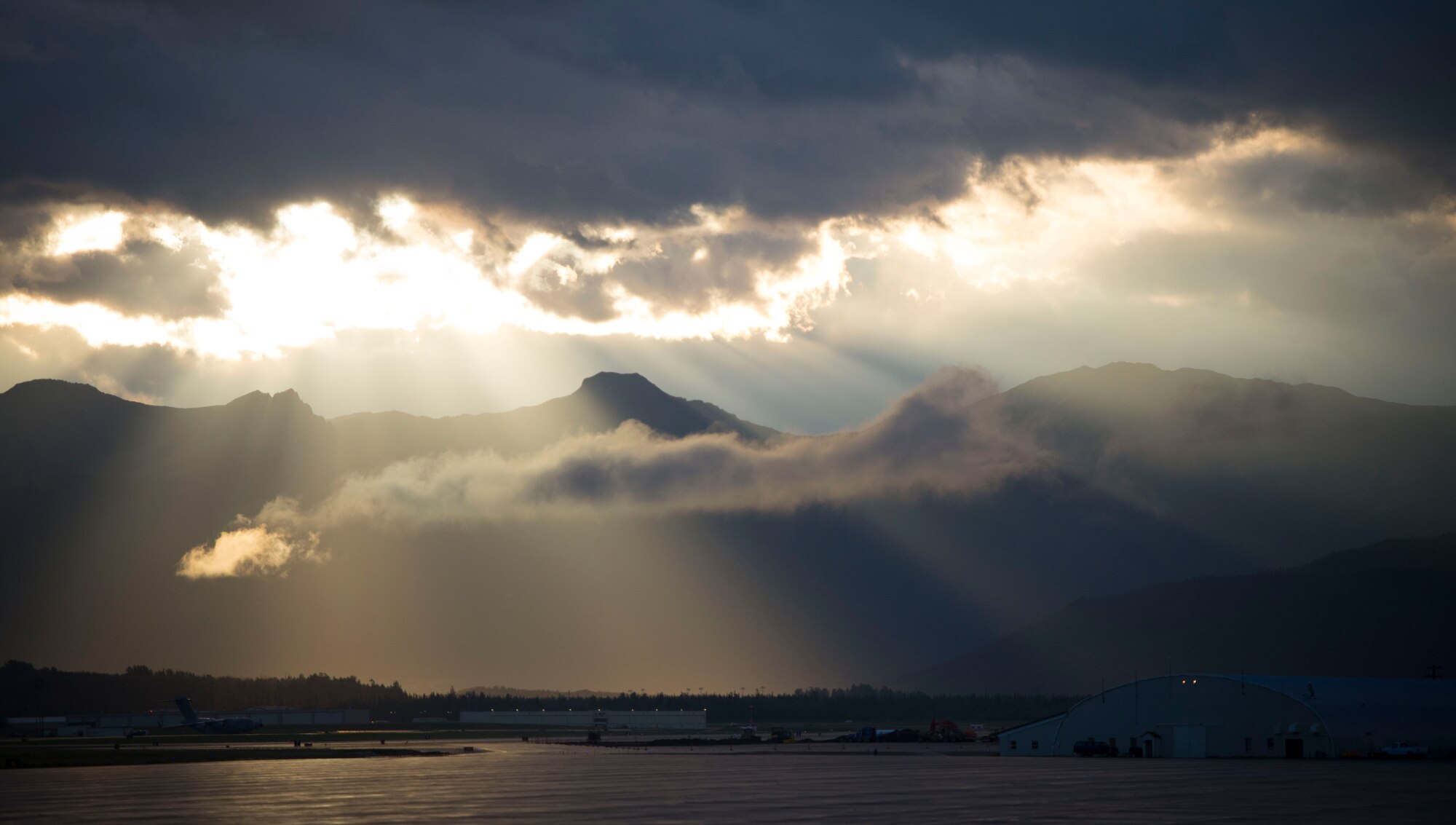 The sun rises over a mountain range near Joint Base Elmendorf-Richardson, Alaska, during the first day of Exercise Red Flag Aug. 11, 2014. The mountains play a vital role in the exercise allowing pilots the opportunity to fly in different environments. (U.S. Air Force photo by Staff Sgt. Chad C. Strohmeyer/Released)
