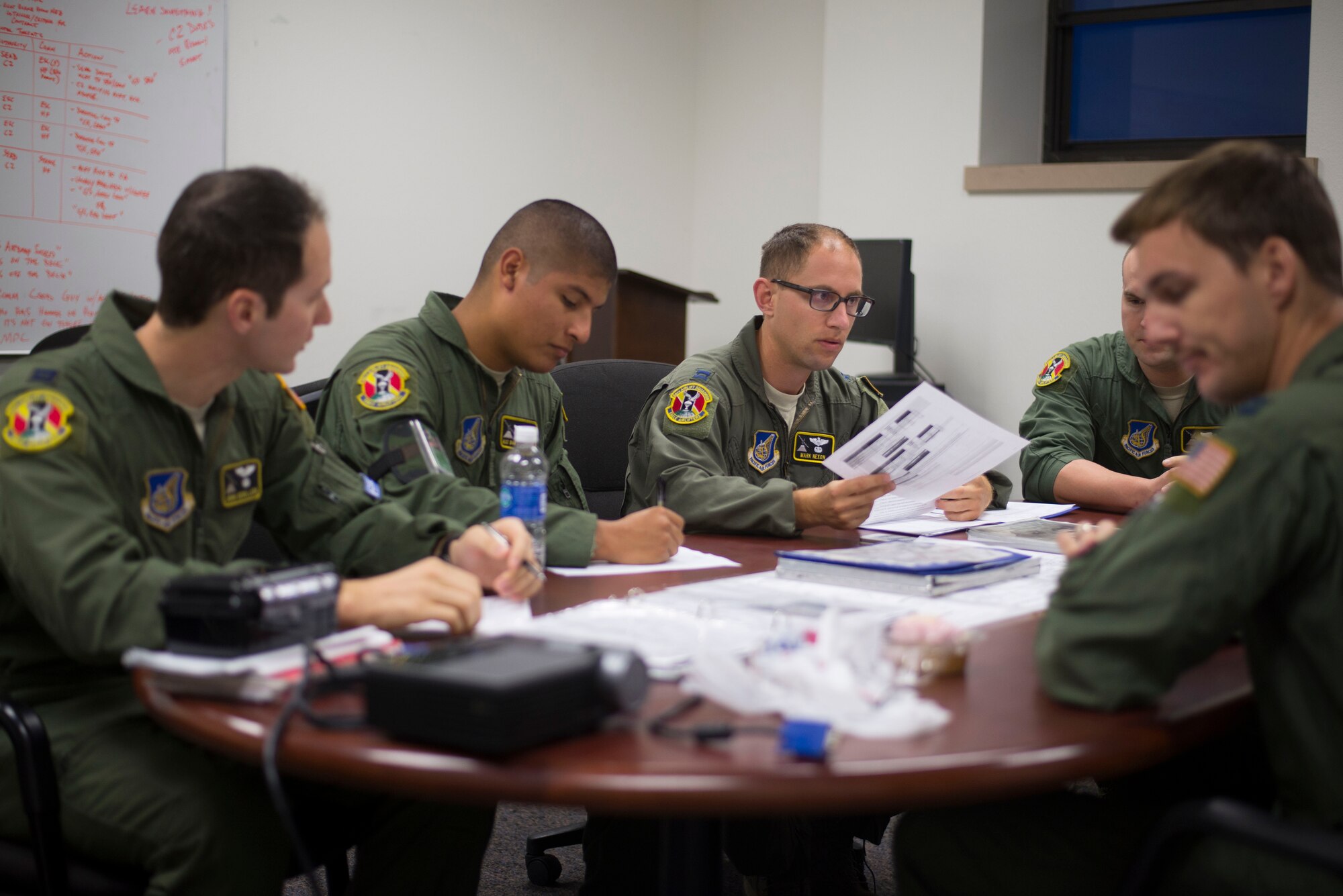 Members from the 36th Airlift Squadron discuss their training sortie during the first day of Exercise Red Flag Aug. 11, 2014, Joint Base Elmendorf-Richardson, Alaska. Red Flag is an exercise that provides joint offensive counter-air, interdiction, close air support, and large force employment training in a simulated combat environment. (U.S. Air Force photo by Staff Sgt. Chad C. Strohmeyer/Released)
