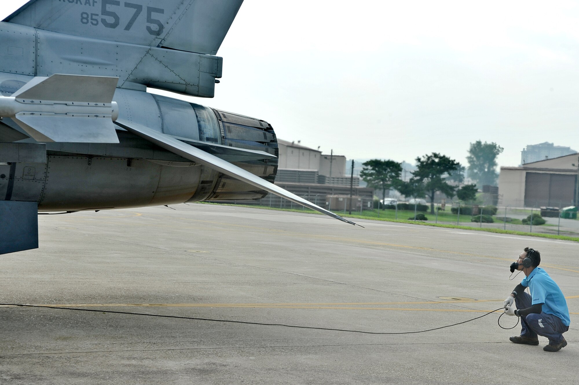Republic of Korea air force Master Sgt. Kyoung won Kim, 161st Squadron crew chief, conducts preflight checks during the Buddy Wing 14-6 exchange program on Osan Air Base, ROK, July 31, 2014. During Buddy Wing, members from each air force shared tactics and procedures to become familiar with how each other work during missions. (U.S. Air Force photo by Senior Airman Matthew Lancaster)