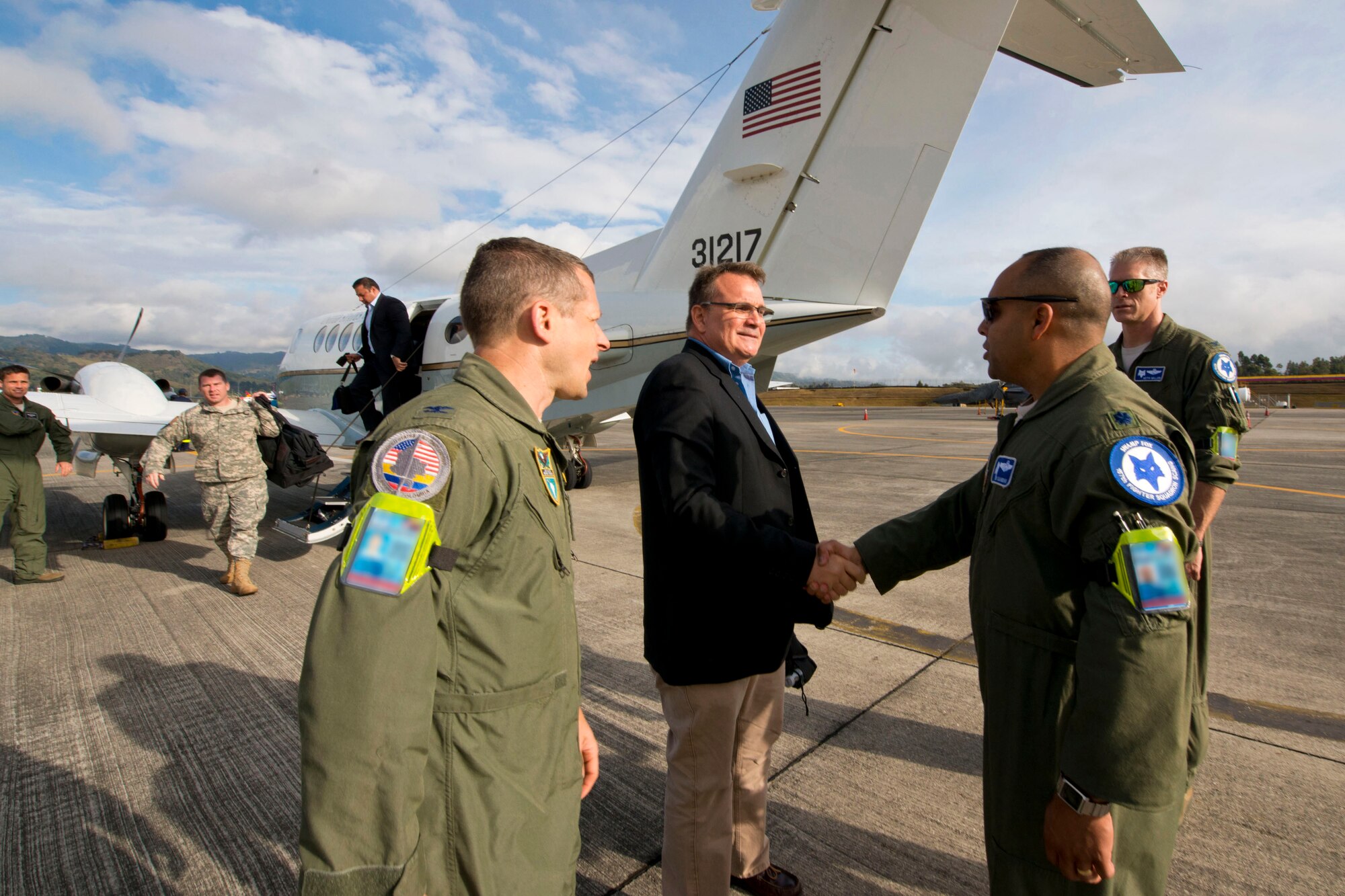 U.S. Air Force Lt. Col.Akshai Ghandi, the 157th Fighter Squadron commander assigned to the 169th Fighter Wing at McEntire Joint National Guard Base of the South Carolina Air National Guard, greets Mr. Benjamin Ziff, Deputy Chief of Mission for the U.S. Embassy in Colombia, during the first day of Relampago (Lightning) 2014, Rionegro, Colombia, Aug. 11, 2014. Relampago is a combined air cooperation engagement with the Republic of Colombia. One hundred Airmen and six F-16s from the 169th Fighter Wing will participate in the first major joint-air training opportunity under the auspices of the South Carolina National Guard's State Partnership Program with the country of Colombia. (U.S. Air National Guard photo by Tech. Sgt. Jorge Intriago/Released)

 
