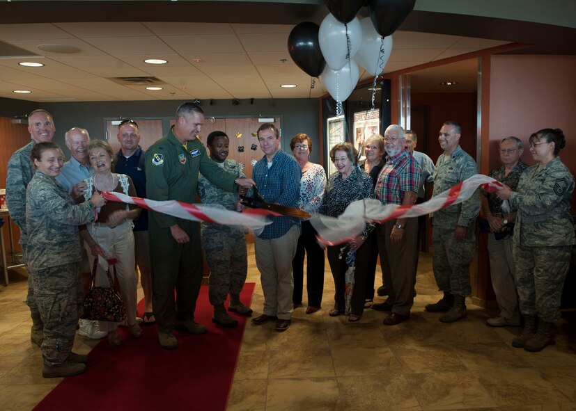 U.S. Air Force Col. Steven Beasley, 7th Bomb Wing vice commander, and Chief Master Sgt. Eddie Webb, 7th Bomb Wing command chief, cut a ribbon marking the reopening of the base movie theater Aug. 8, 2014, at Dyess Air Force Base, Texas. The base theater is now playing movies every Friday, Saturday and Sunday, for free to anyone with base access.  Food, snacks, beverages to include adult beverages and Starbucks products will be available for purchase. (U.S. Air Force photo by Airman 1st Class Kylsee Wisseman/Released) 