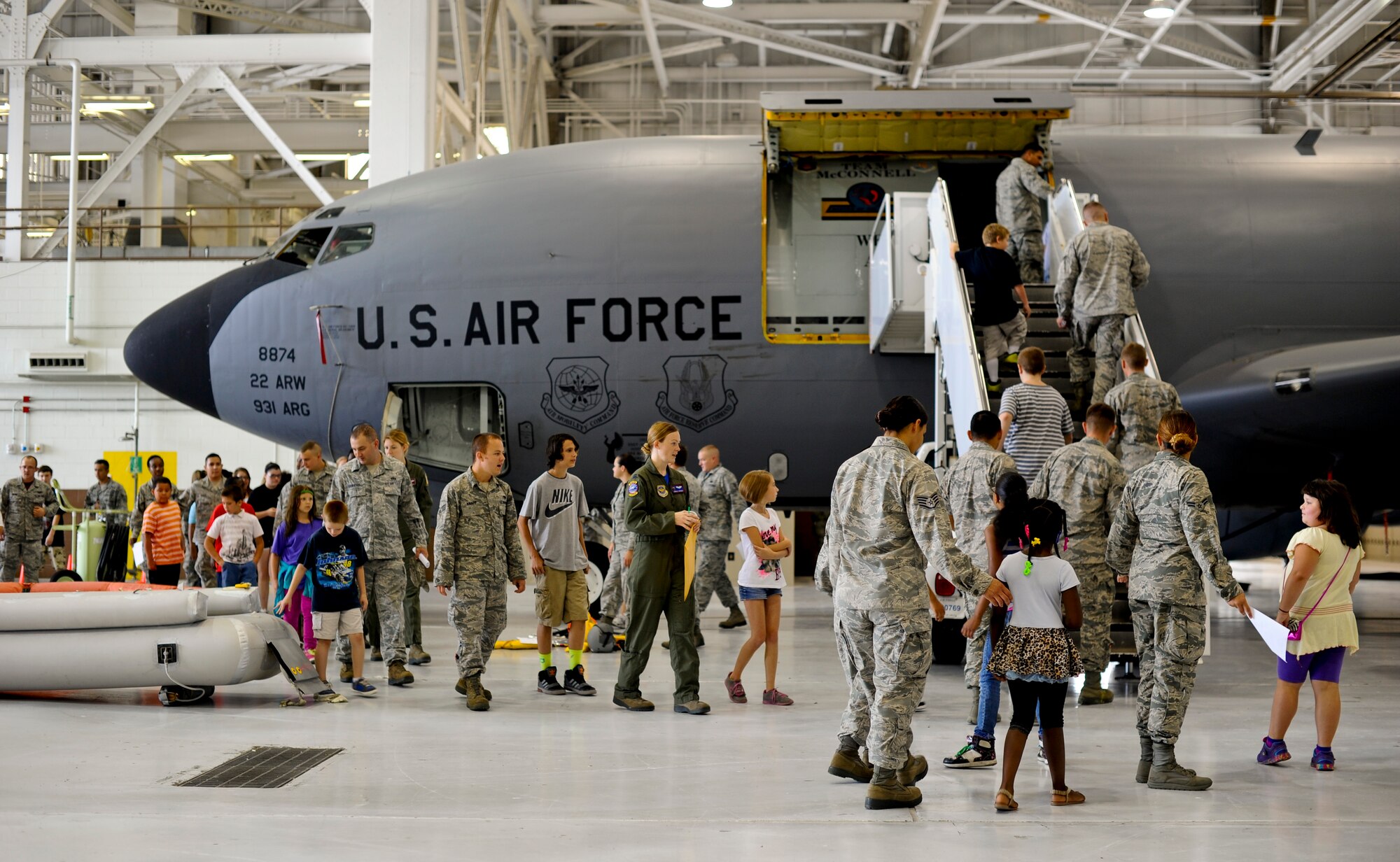 Youths and Airmen explore a KC-135R Stratotanker, Aug. 8, 2014, at McConnell Air Force Base, Kan. The Sedgwick County chapter of Big Brothers Big Sisters visited for the annual "Big for a Day" event, sponsored by the 349th Air Refueling Squadron. ‘Littles’ were matched with Airmen ‘Bigs’ to experience a day in the life of an Airman in the Air Force. (U.S. Air Force photo/Airman 1st Class John Linzmeier)