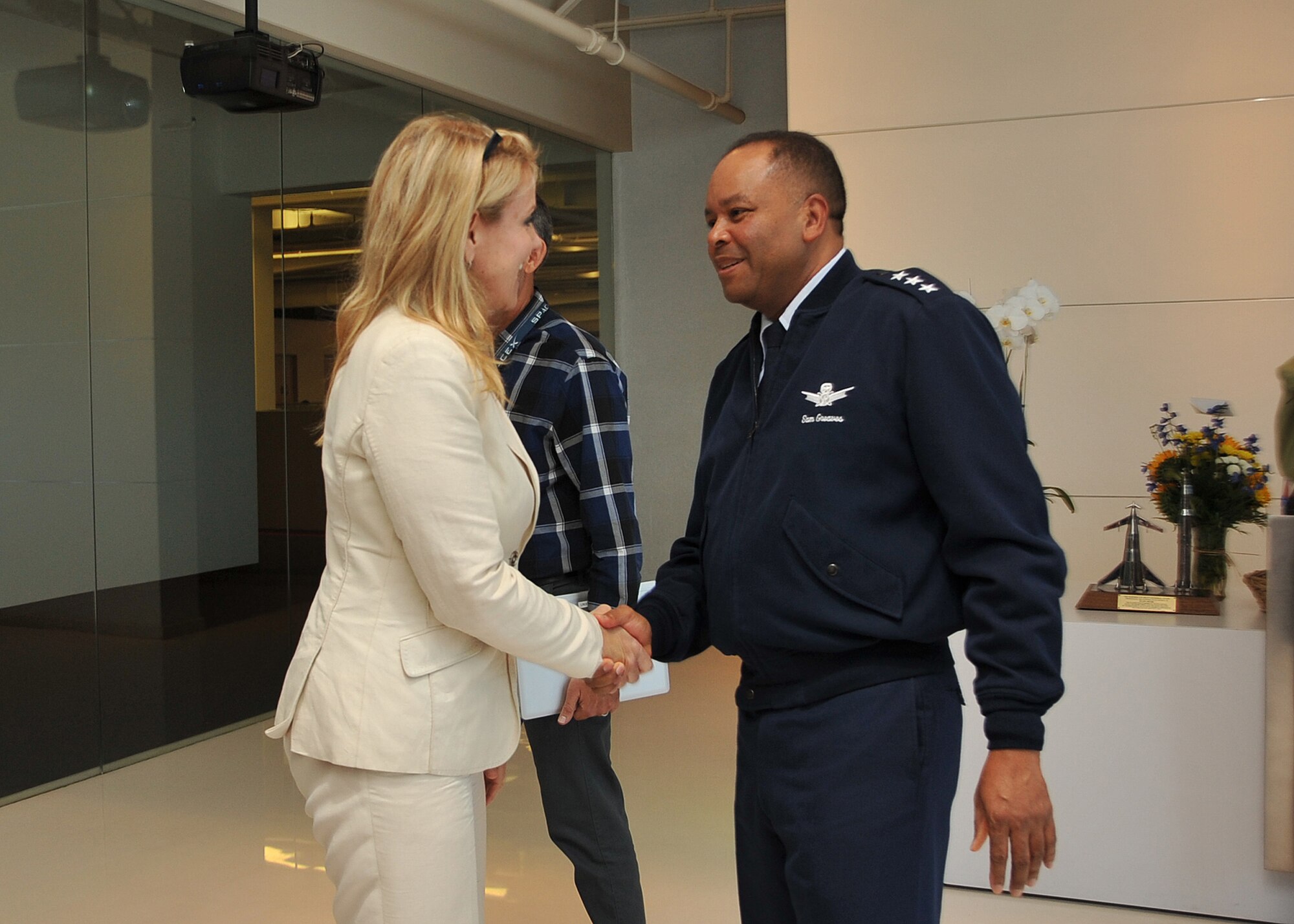 U. S. Air Force Lt. Gen. Sam Greaves, Space and Missile Systems Center commander, meets with Gwynne Shotwell, president of Space Exploration Technologies Corp., before a tour of SpaceX's Hawthorne, Calif., facility Aug. 7, 2014. (U.S. Air Force photo by Sarah Corrice)